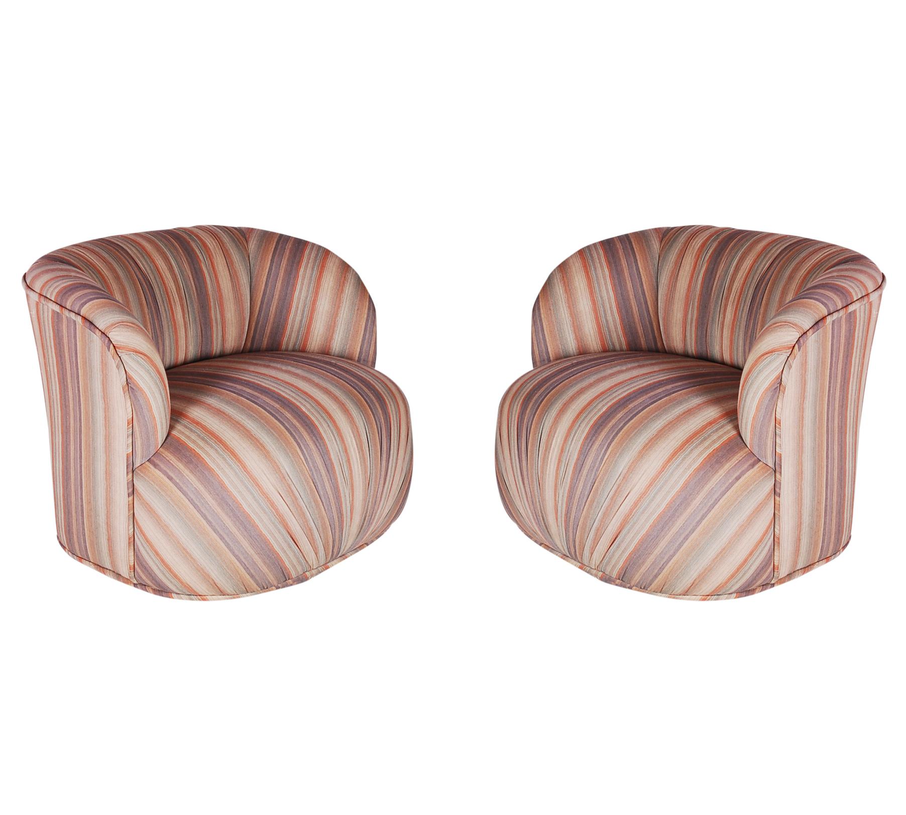 A matching pair of bubble / pouf form lounge chairs. Both are in original fabric and need recovering. Foam, padding and swivel mechanisms are fine. We offer upholstery services.