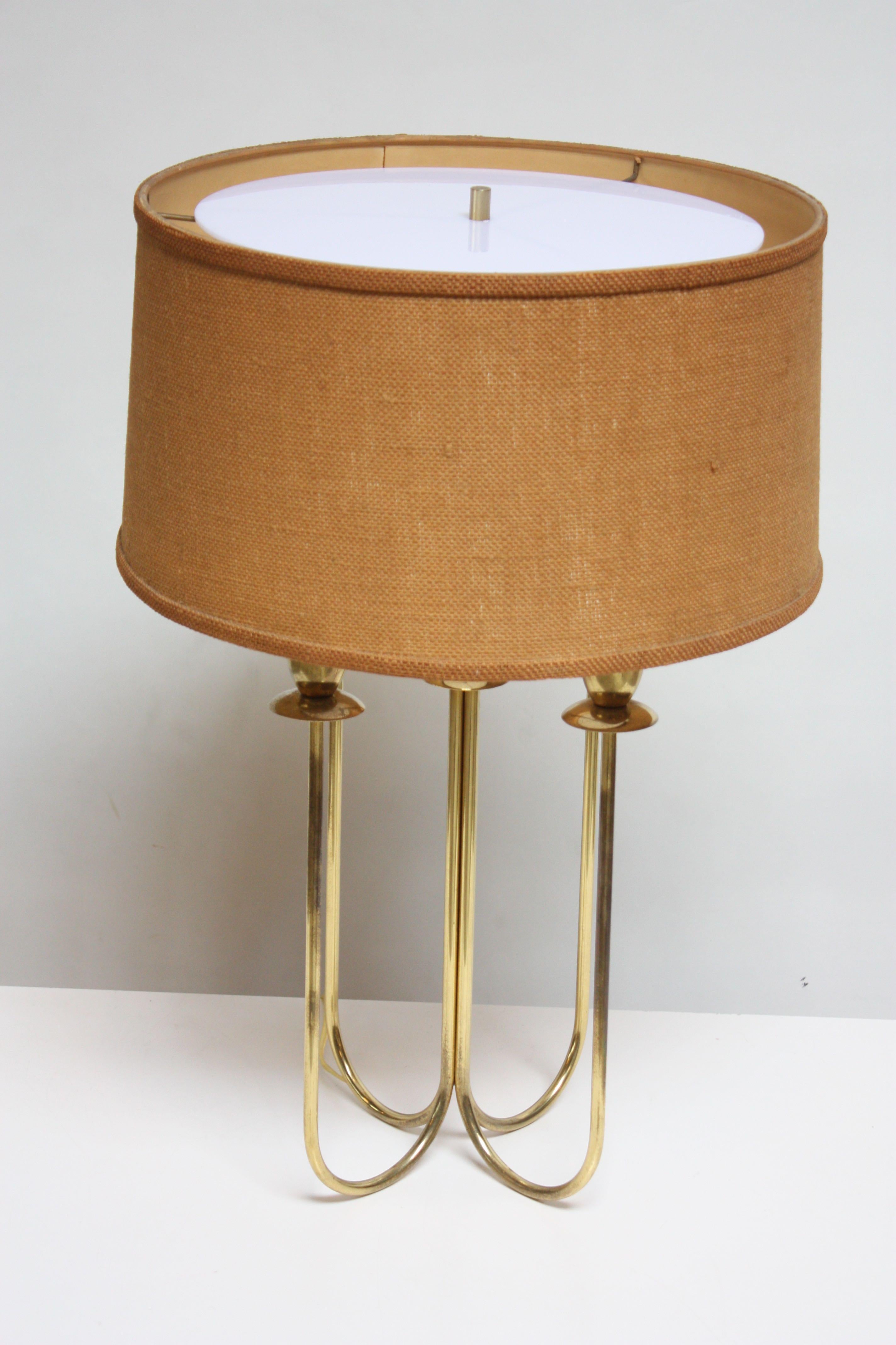 Mid-century brass table lamp composed of four-fixtures and corresponding 'tapers' that intersect at a central stem. Paired with a beige woven-linen shade and newly fabricated acrylic diffuser for even light distribution. Brass has been left