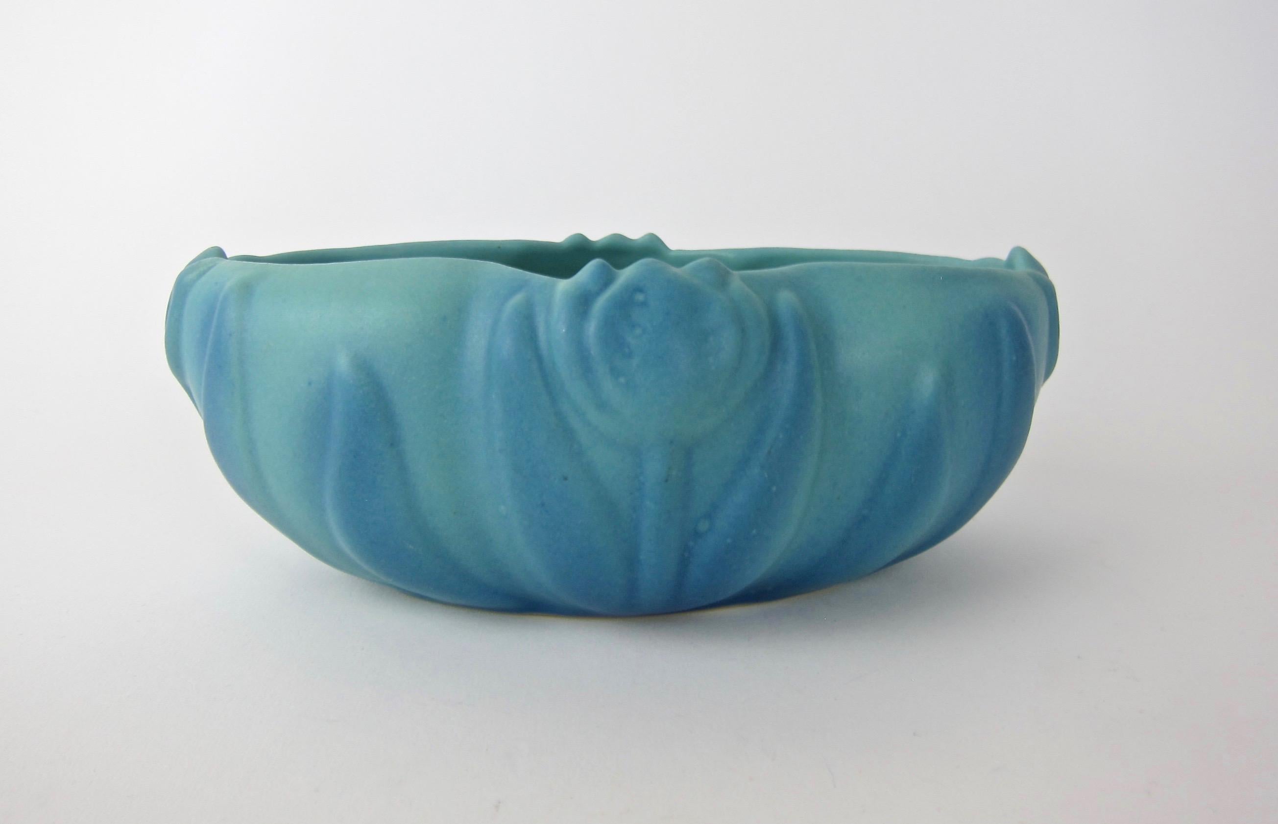 A signed vintage American art pottery planter bowl from Van Briggle Pottery of Colorado Springs, founded in 1901 by Artus Van Briggle. The vessel dates to the 1920s. The oblong shape features Art Nouveau tulip decor enveloped in the company's