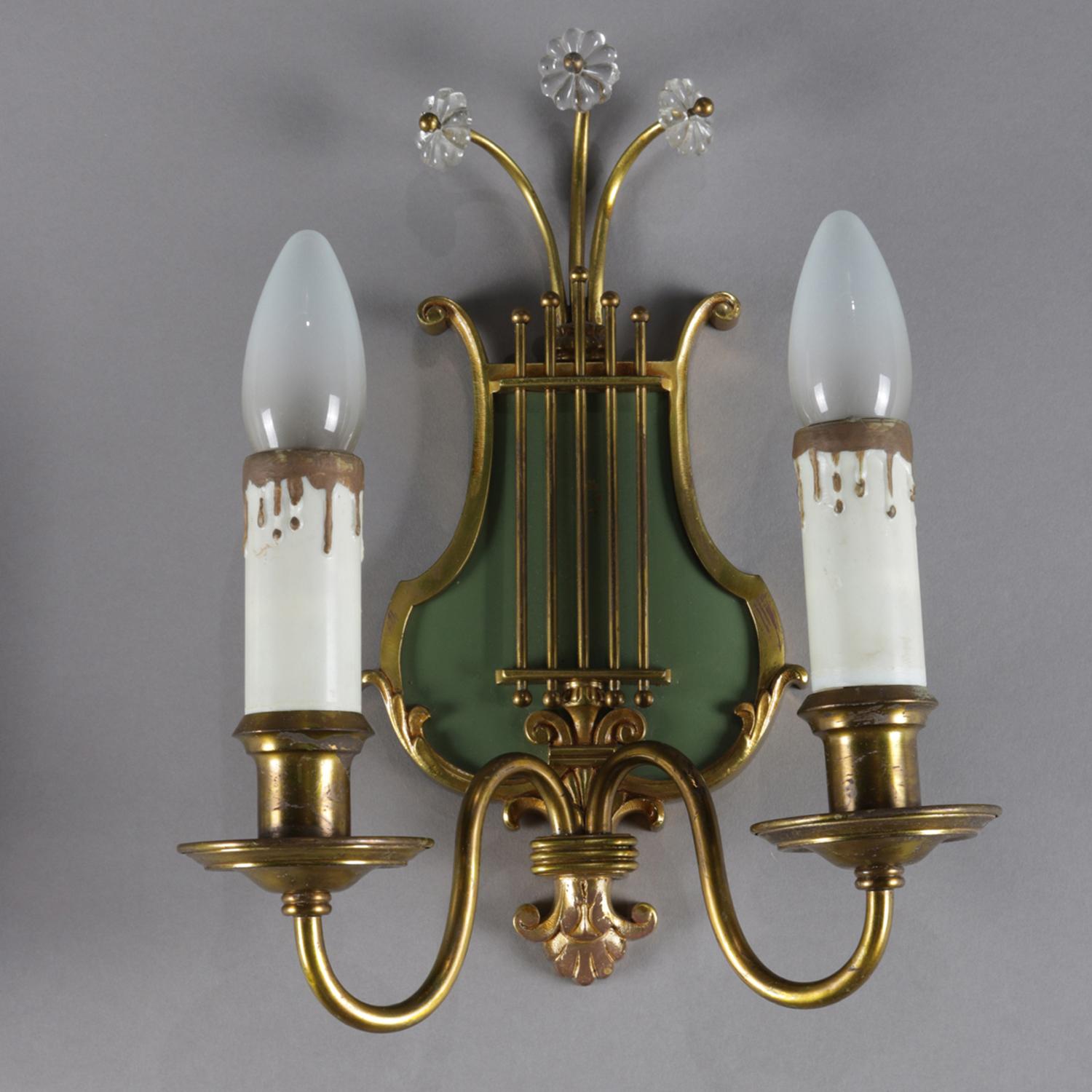 Pair of vintage wall sconces feature foliate decorated lyre form with crest having crystal flower form highlights and surmounting two candle lights on S-scroll arms with lower central fleur de lis finial, 20th century

Measures: 11.5