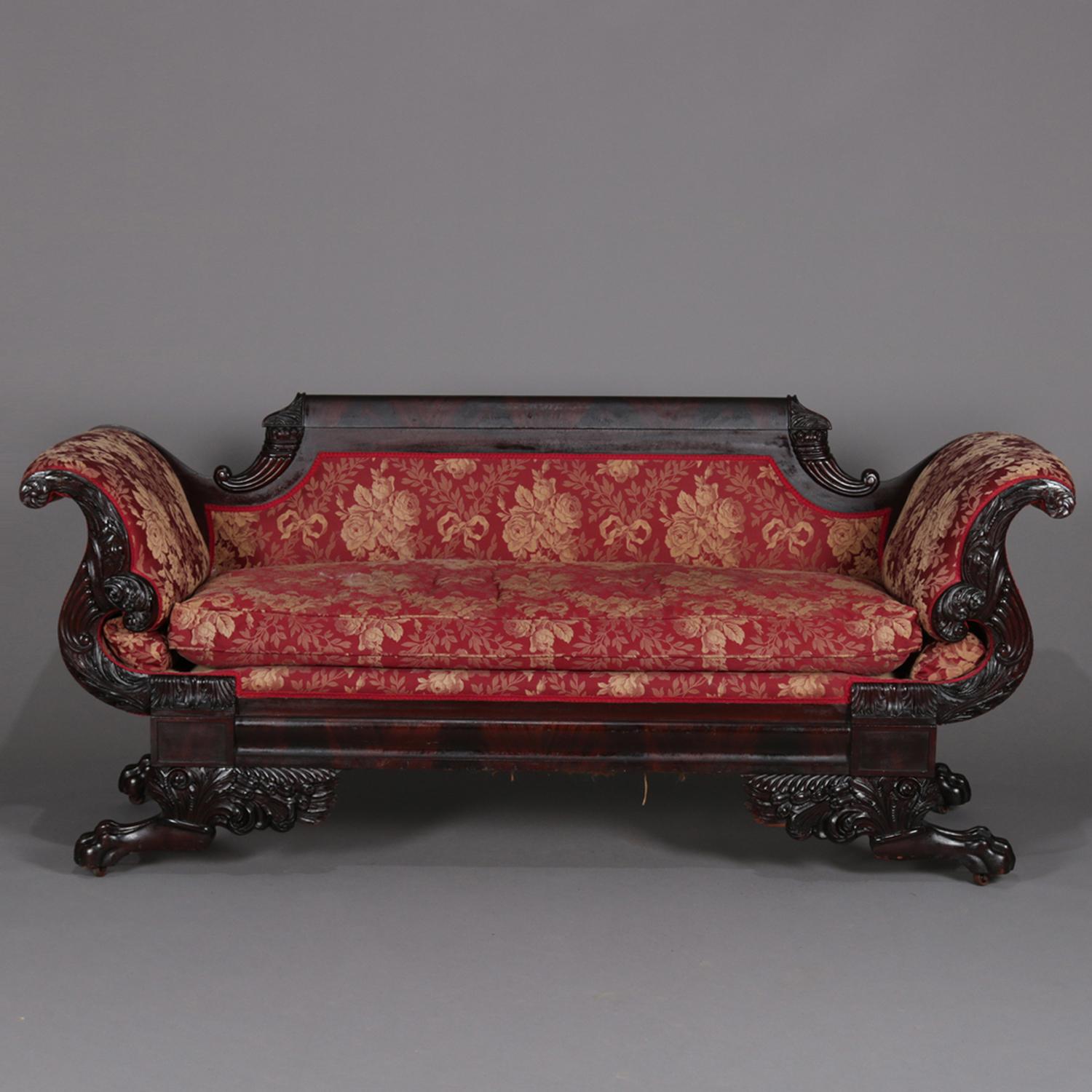 Antique First Period American Empire classical pair matching sofas feature carved mahogany frame with back rail flanked by concave and carved cornucopia over scrolled arms with carved overflowing cornucopias with rosettes in the scroll and acanthus
