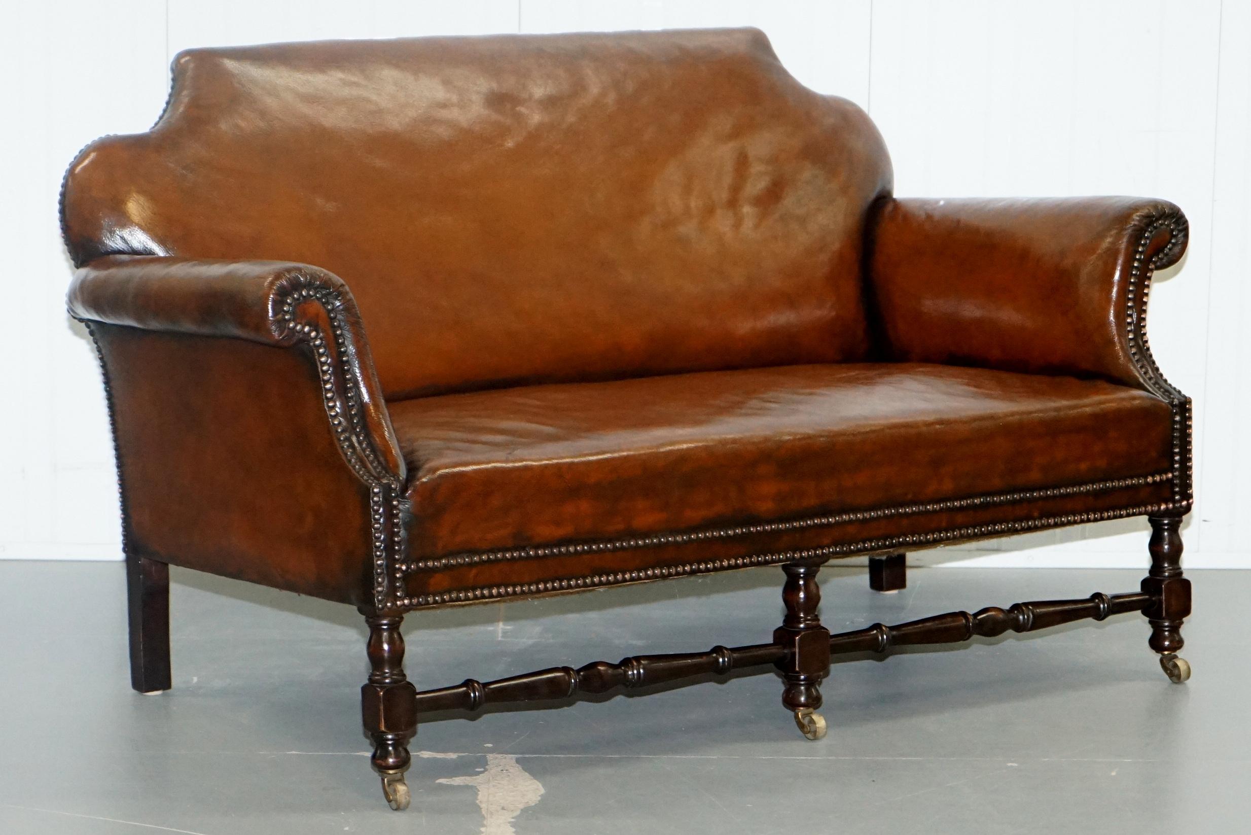 We are delighted to offer for sale this stunning very rare fully restored cigar brown leather Humpback Gentleman's club suite with a hand-turned mahogany frame finished with brass castors.

Where to begin! This suite is absolute eye candy from