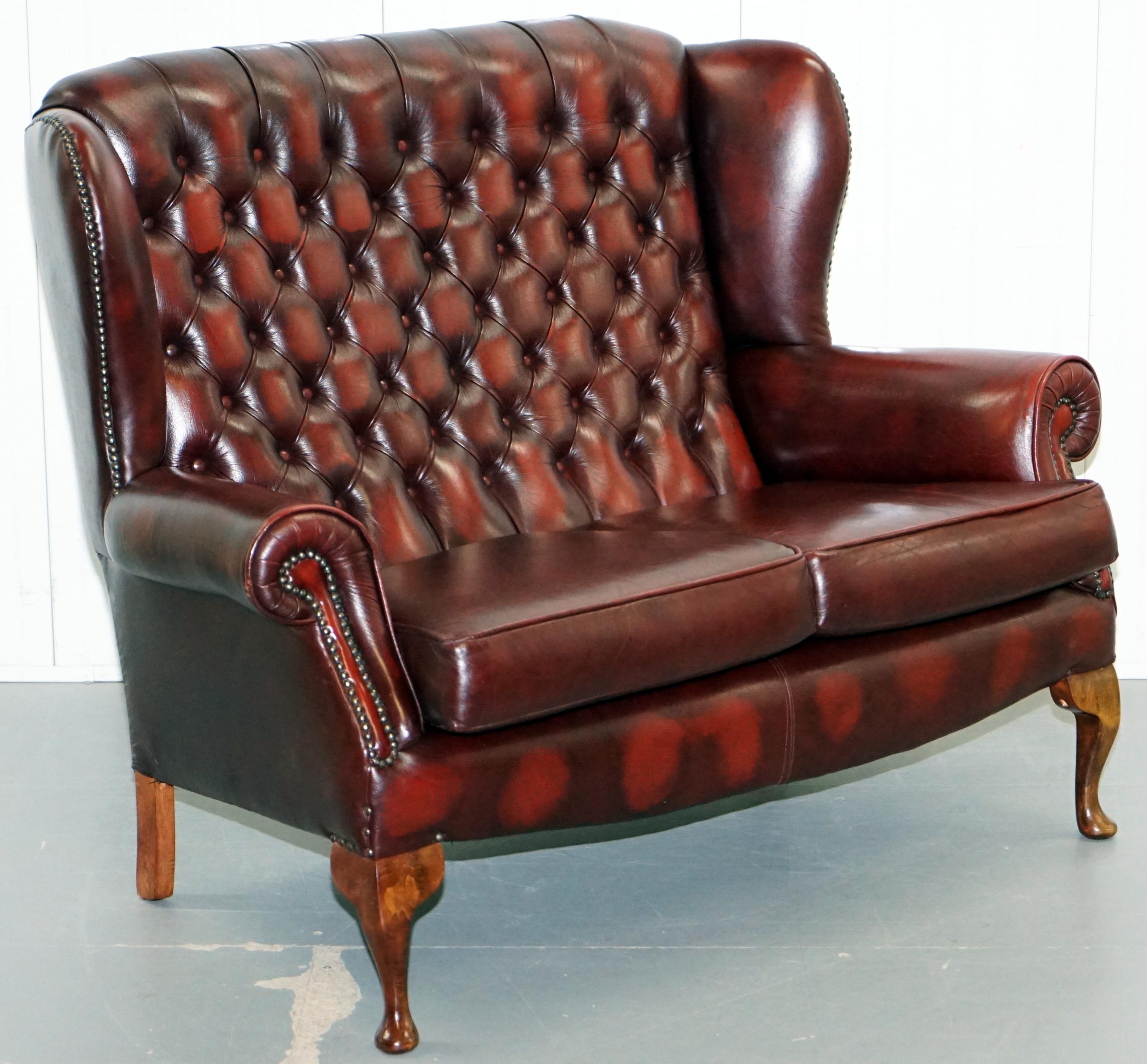We are delighted to offer for sale this very nice hand dyed oxblood leather Chesterfield wingback two-seat bench sofa

This piece is in lightly restored condition to include a deep clean hand condition wax and hand