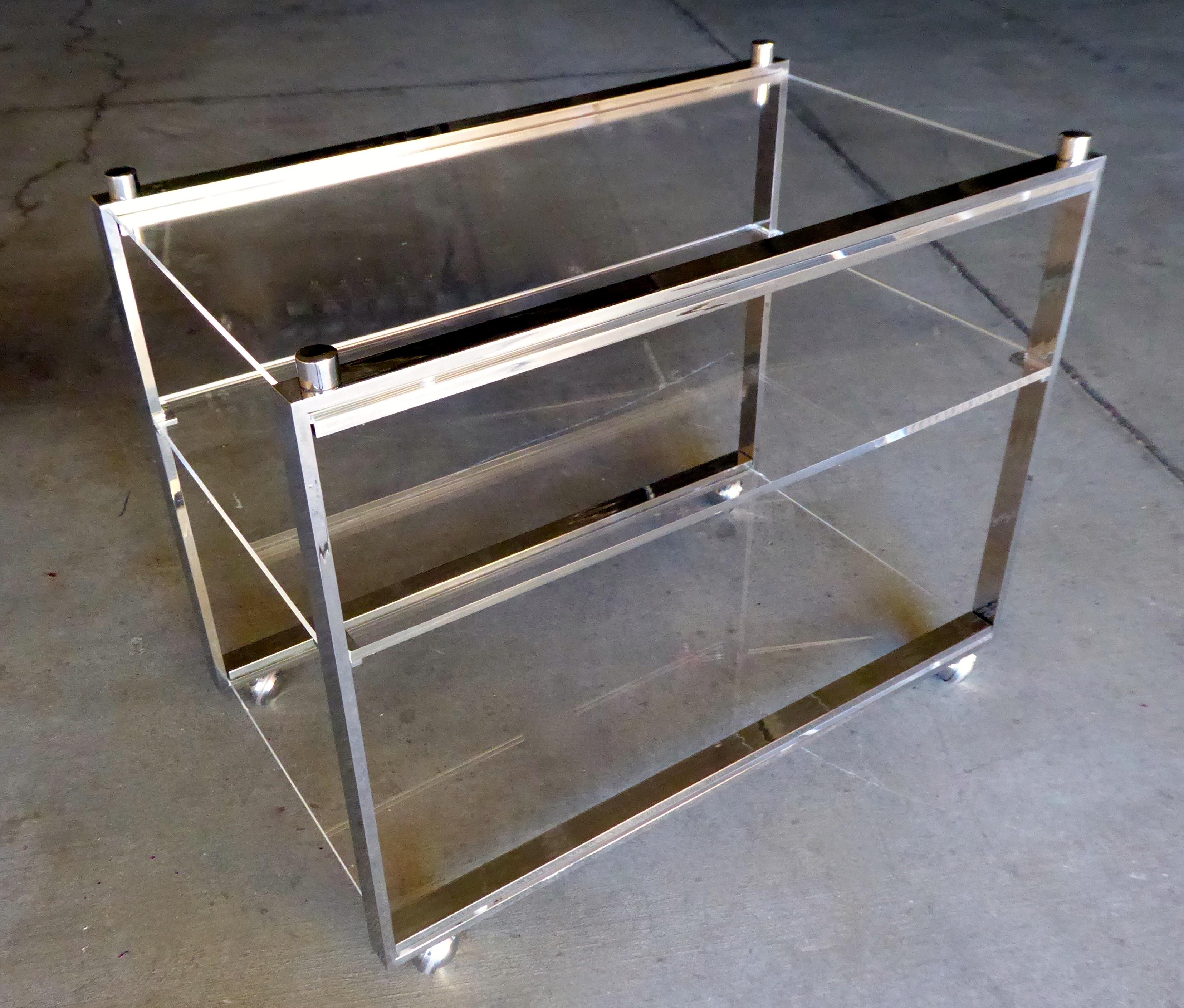 A chrome-plated steel and Lucite three-level serving cart from the Box Line designed by Charles Hollis Jones for Hudson-Rissman, circa 1960s. This serving cart was created in 1968.