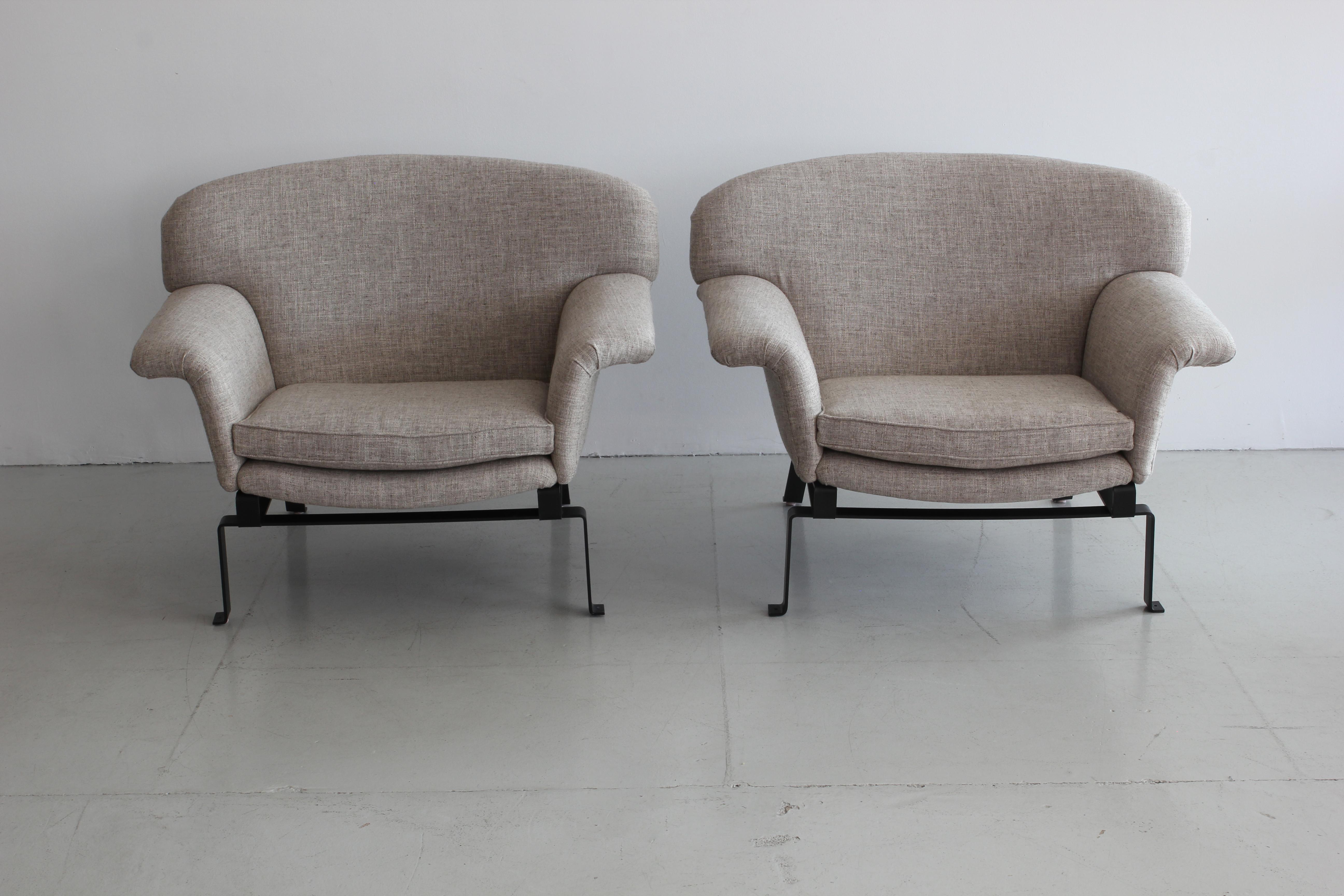 Fantastic shaped Italian chairs with wing arms and iron floating base. 
Newly upholstered in linen.