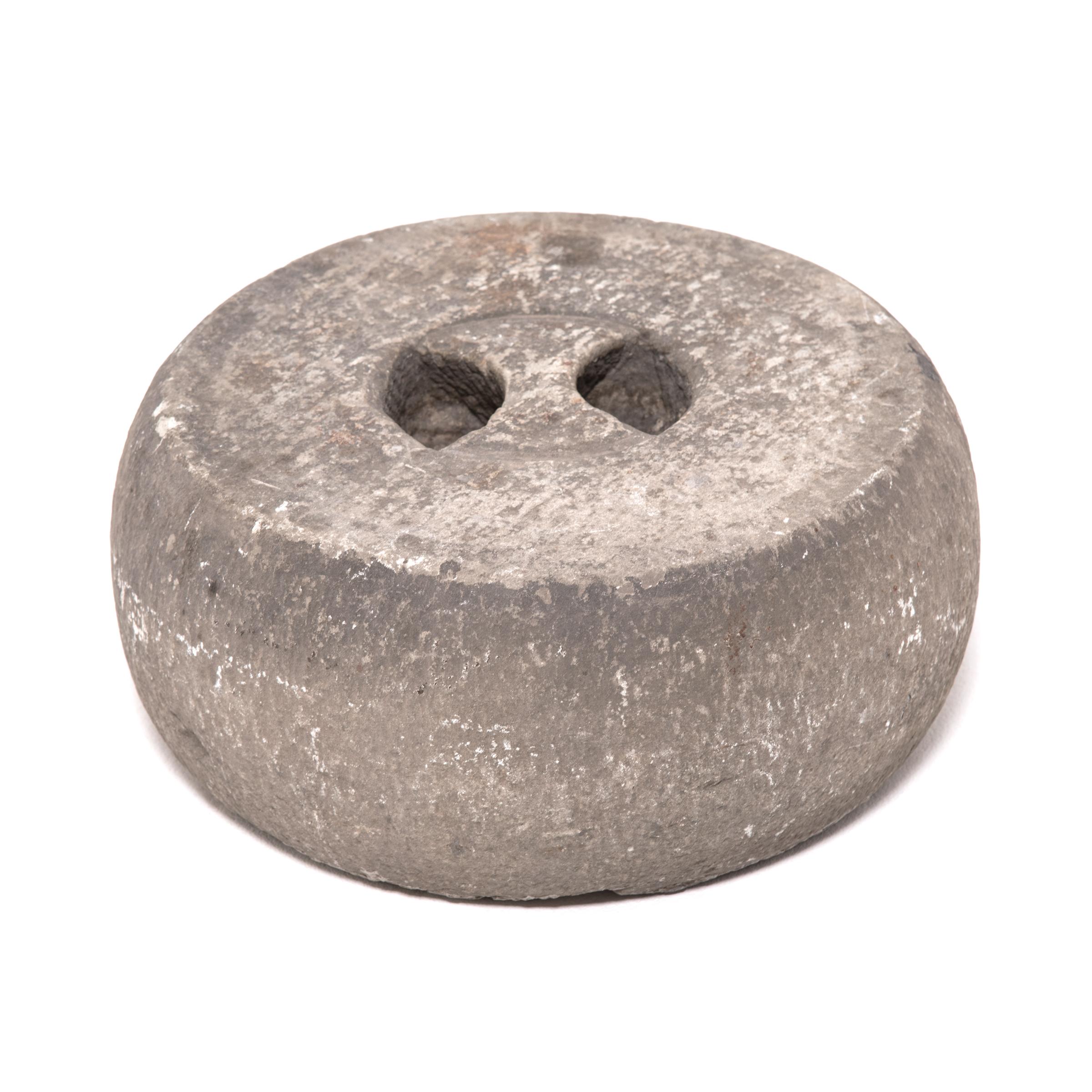 Once used as part of intensive martial arts training, this 19th-century Chinese round weight was carved from limestone and used much like a modern kettle bell. Likely threaded with a strong rope, the weight was either swung around or lifted to aid