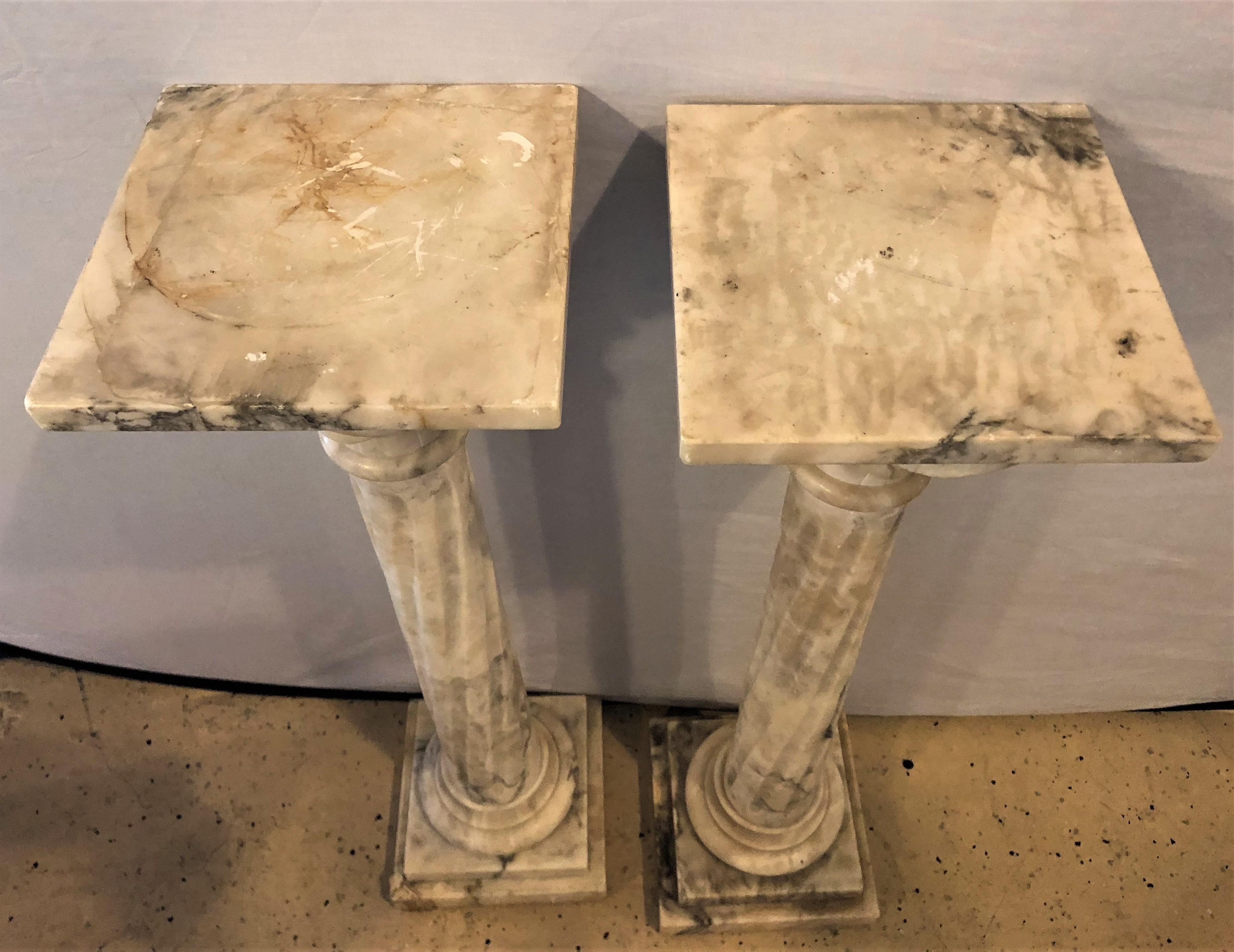 Pair of neoclassical alabaster pedestals grey/white/black Vein Flevr Dis Lis Tops. Each finely decorated and stylish pedestal having a rich gray and black vein on a white background. 

EXX.