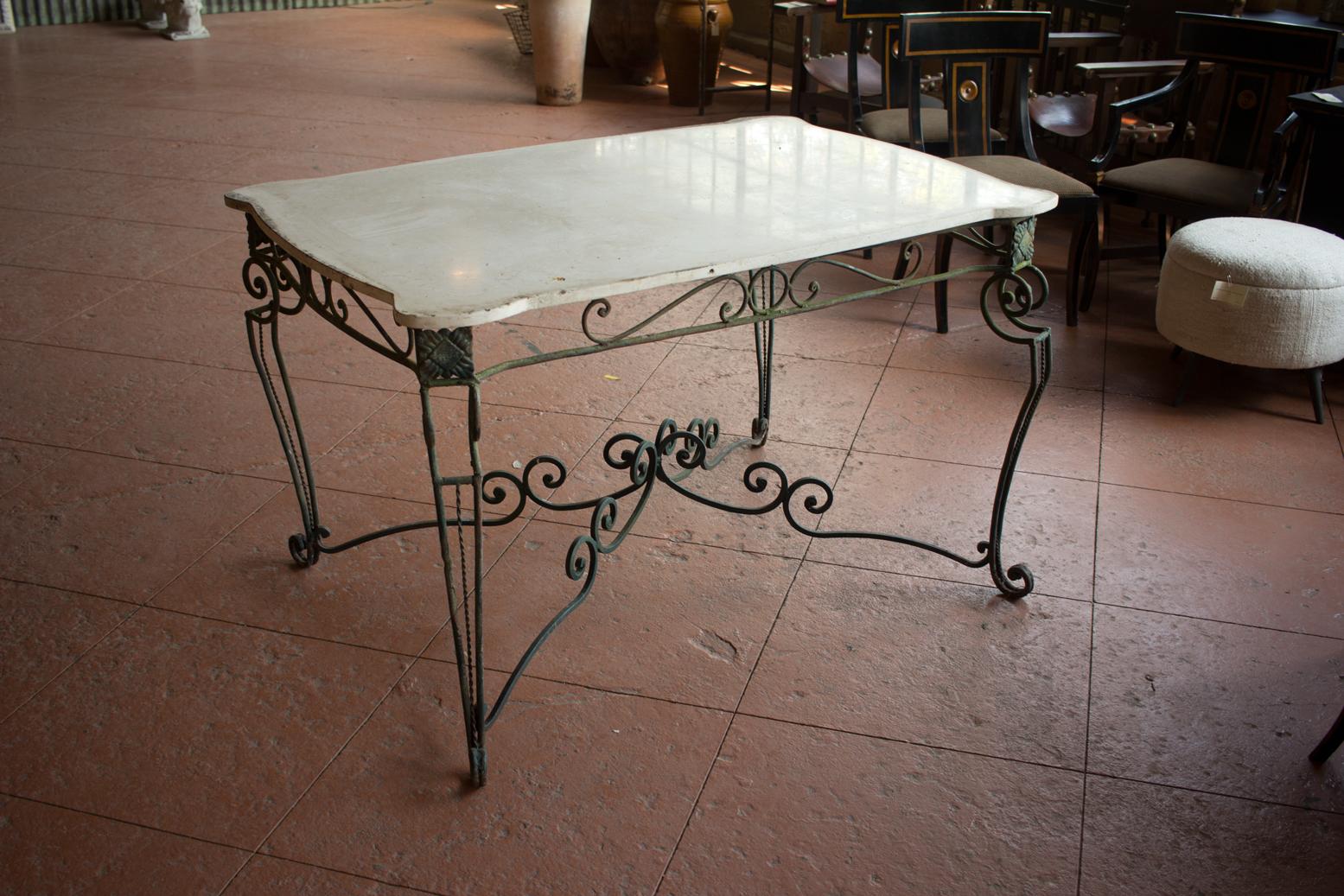 Antique English Art Nouveau rectangular wrought iron garden table with shaped marble top.

The base is beautifully hand-wrought with a lovely original patina.