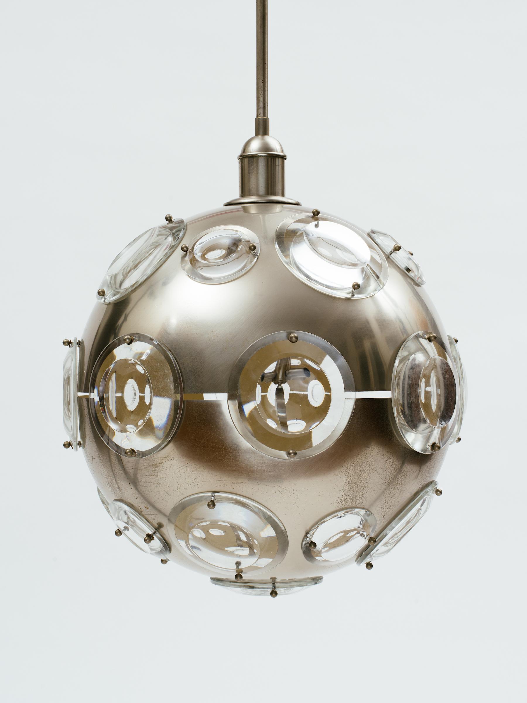 Large Oscar Torlasco brushed steel orb chandelier with beveled glass oculus windows that are illuminated from within. White enamel interior. Original steel rod and ceiling cap.
Italy, circa 1968.
 
