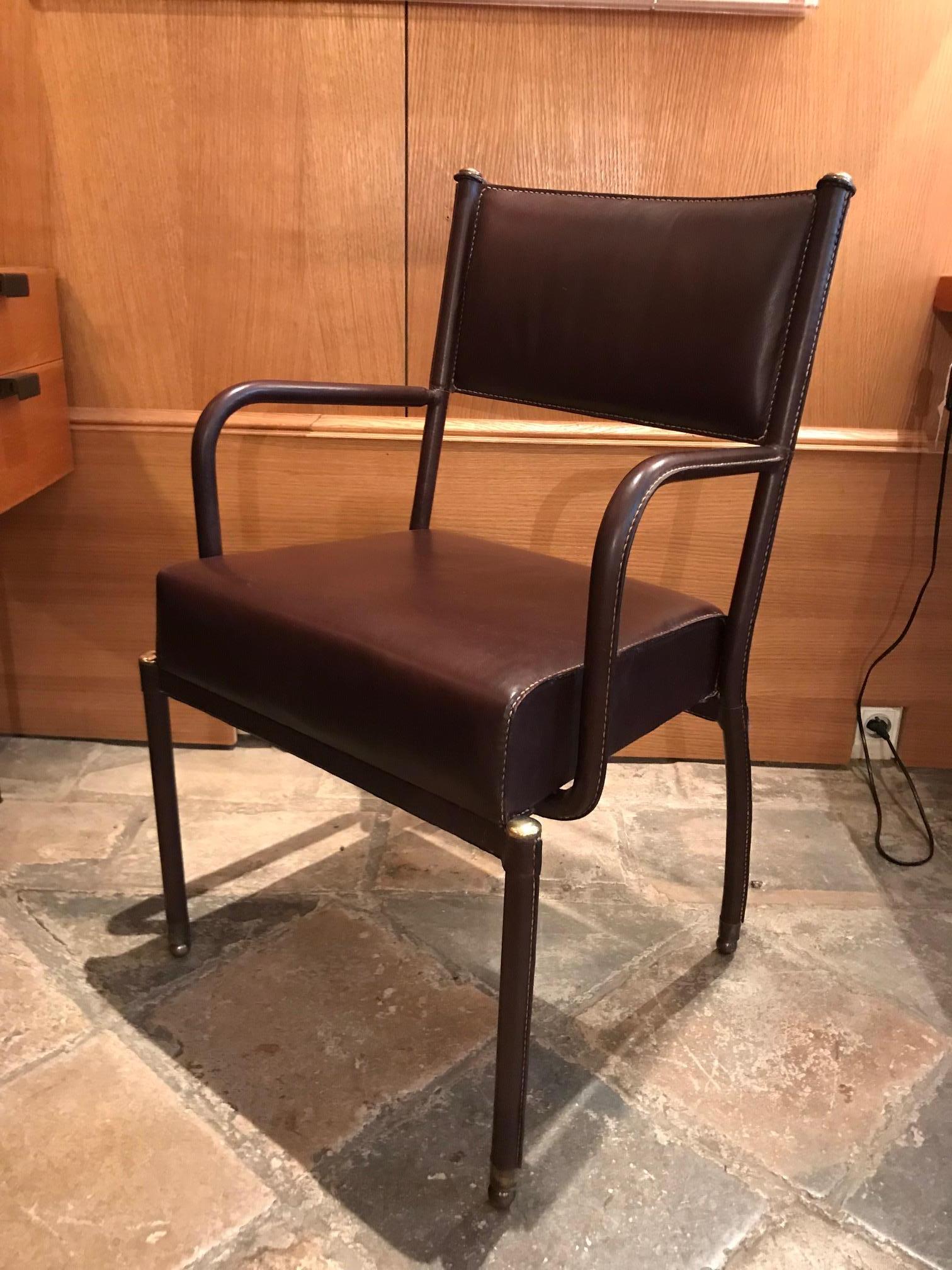 1950s armchair by Jacques Adnet, piqué-sellier chocolate brown leather, brass elements.