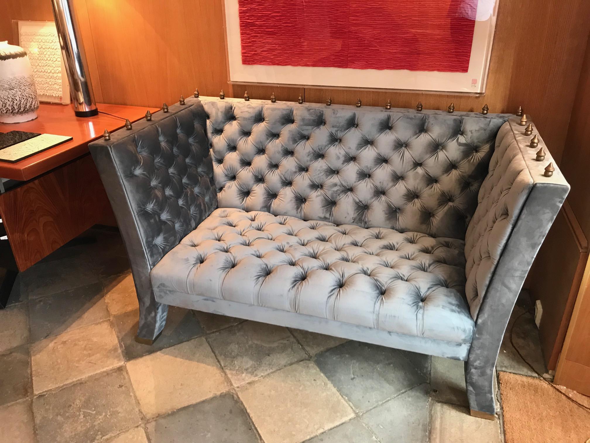 Wide-shape wood sofa upholstered with a grey blue velvet. Quilted fittings. Legs terminating with bronze feet tips. Surmounted with gilt bronze Baroque element.
Model created in 1989.