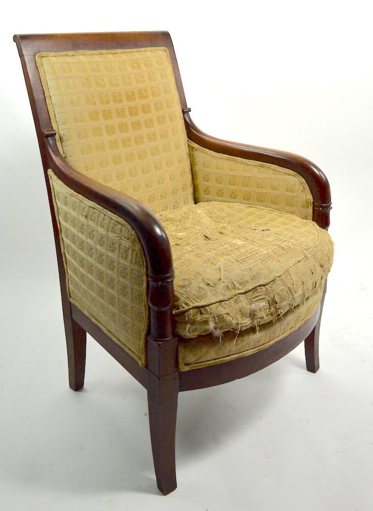 Solid walnut frame, pegged construction, carved wood frame, upholstered seat and back - upholstery worn and will need to be replaced. Rear leg shows minor loss at base, as pictured. We believe this example is American in the French style.