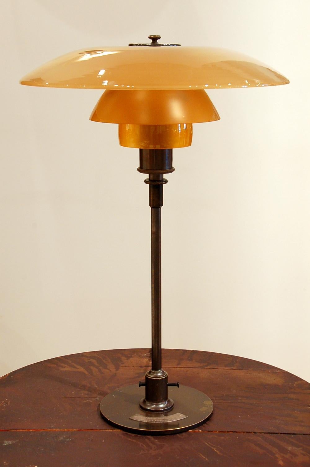 Poul Henningsen (1894 Ordrup, Denmark 1967)
Table light, special commission
4/3 amber shades
Frame with three cast iron legs marked 