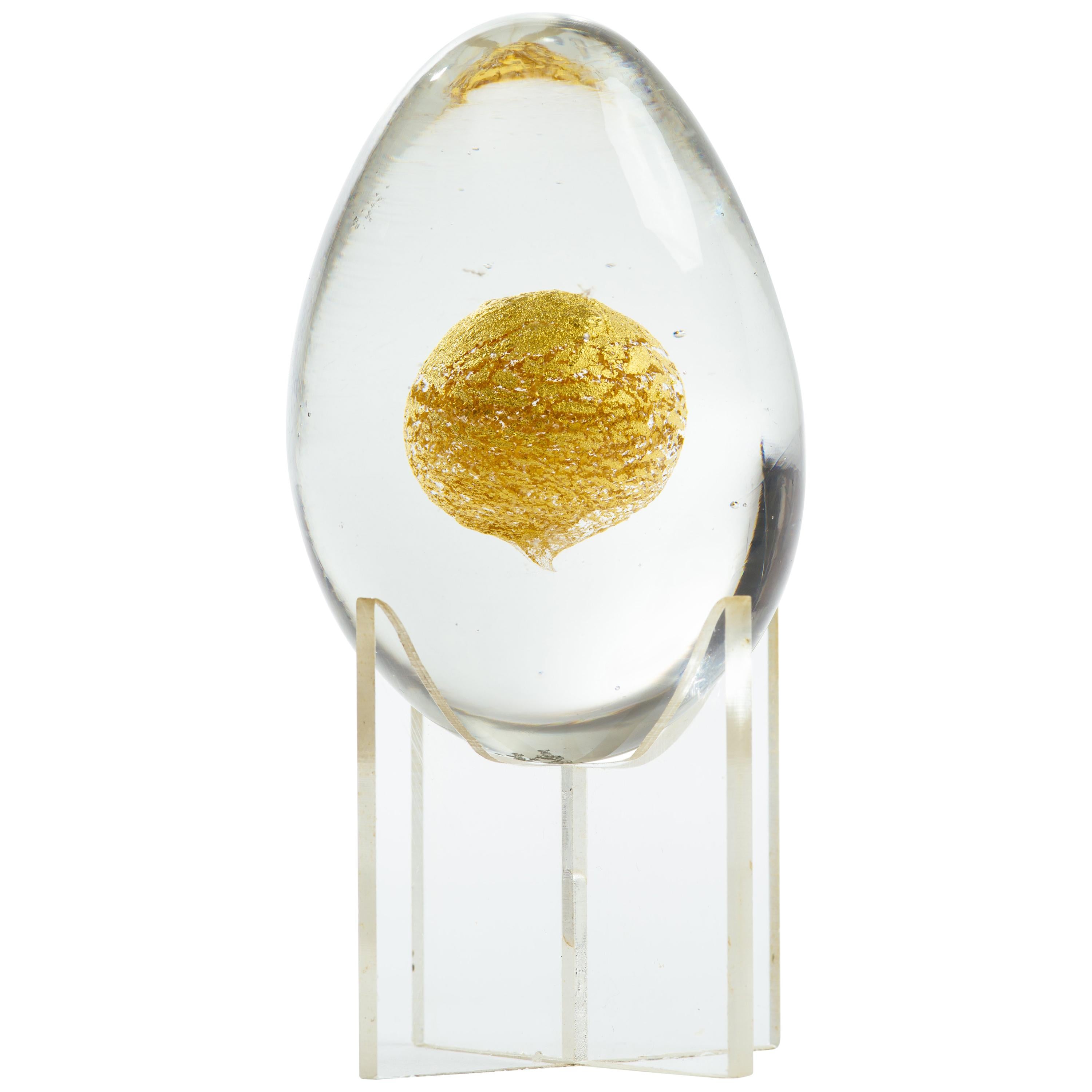 Italian handblown glass egg paperweight sculpture. 24-karat gold orb inclusion with lucite stand,
 Engraved signature on bottom, Venini, Italia. Glass egg without stand measures 2.5 inches height x 2 inches diameter.
