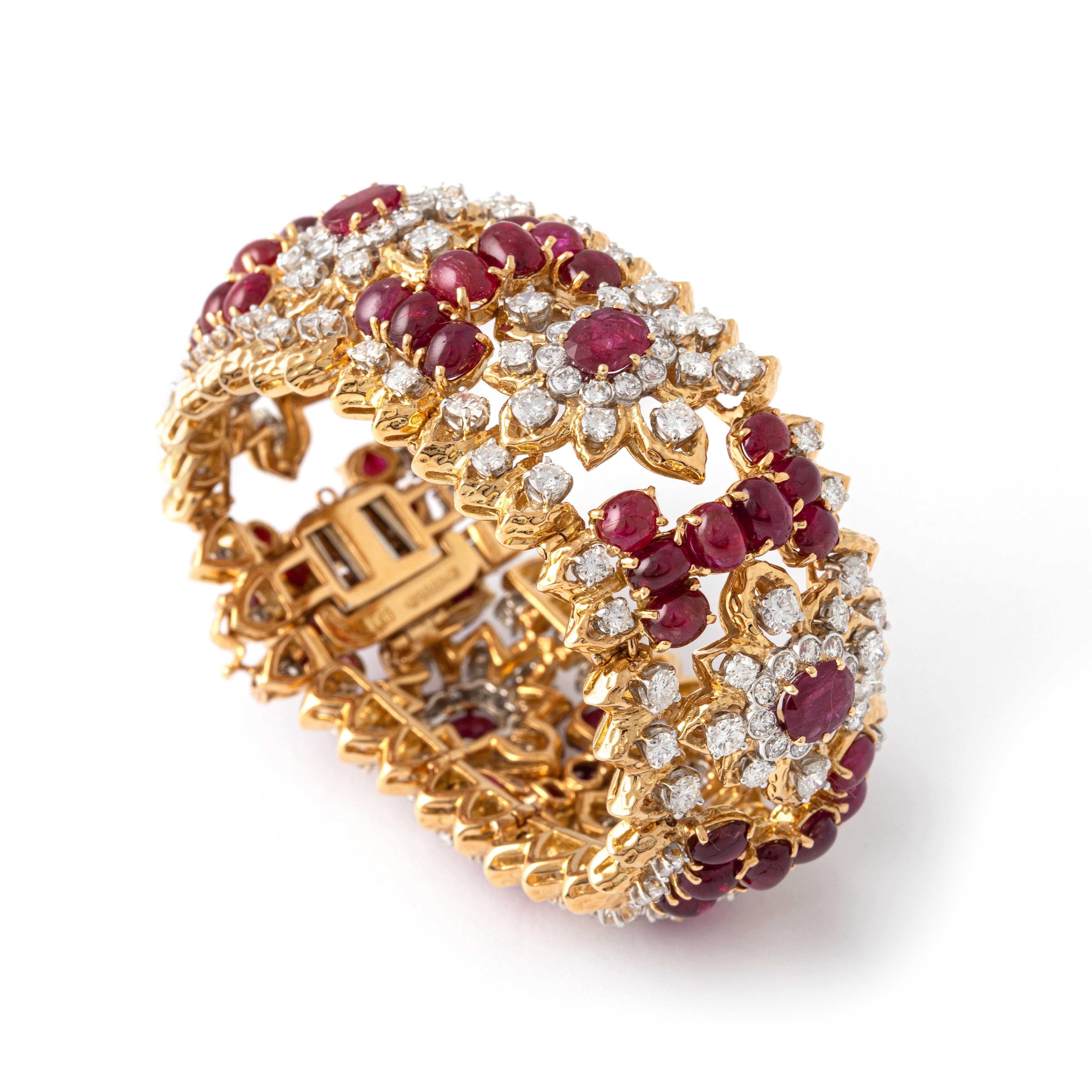 David Webb 18K gold, ruby and diamond bracelet.
The wide openwork strap set with oval rubies weighing approximately 5.00 carats cabochon rubies and round diamonds weighing approximately 15.15 carats. 
Signed Webb.

Width: 3.00 centimeters.
Length: