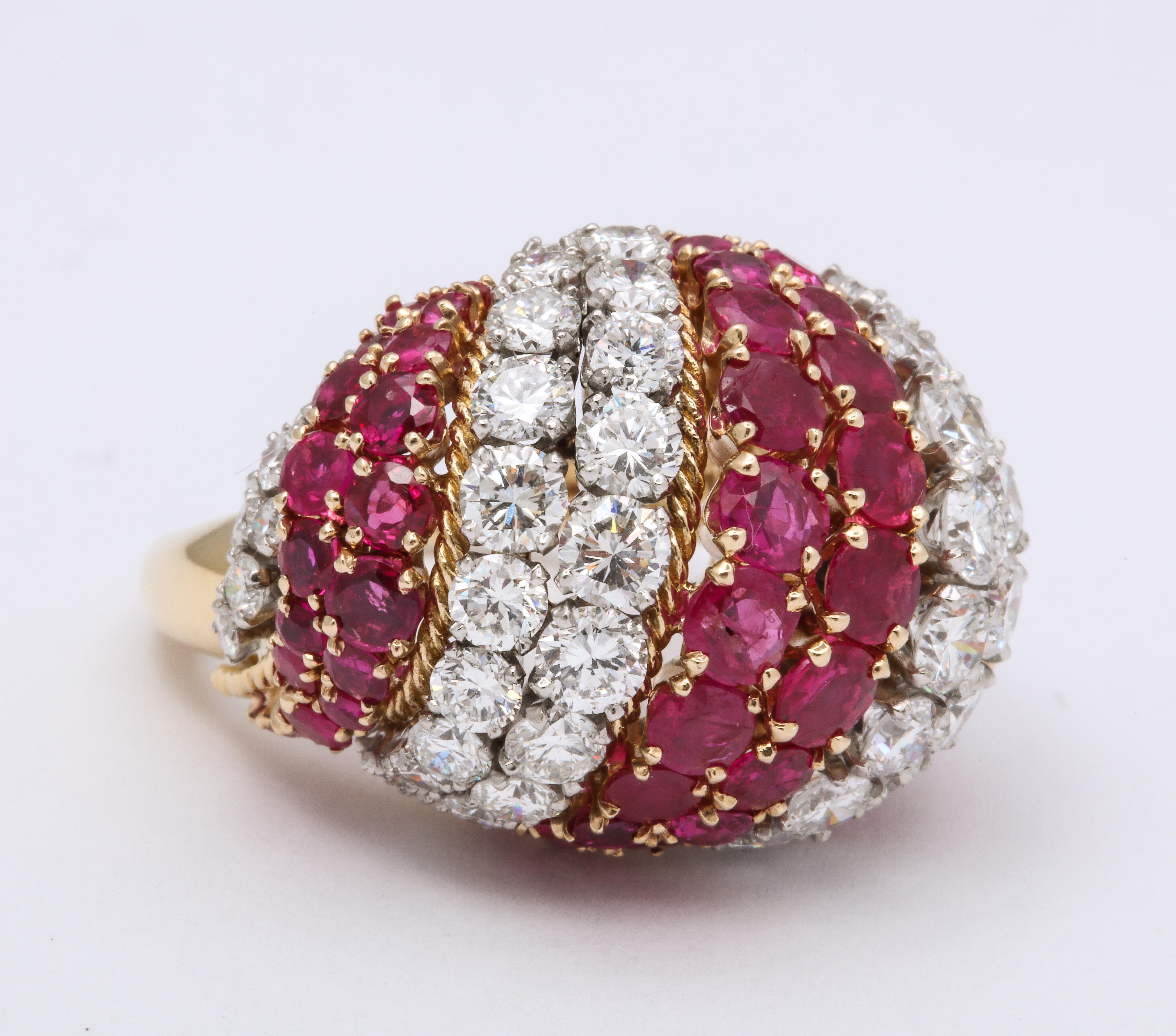 David Webb Diamond and Ruby Bombe ring, circa 1960.   18K Yellow Gold, 20 gr. 
65 single cut rubies @ 1.50, 66 full cut white diamonds @ 8.0 cts .
2 1/4 inches side to side of dome  x 1 3/4 inches across the top.   

Marked David Webb  JA 78, 18K 