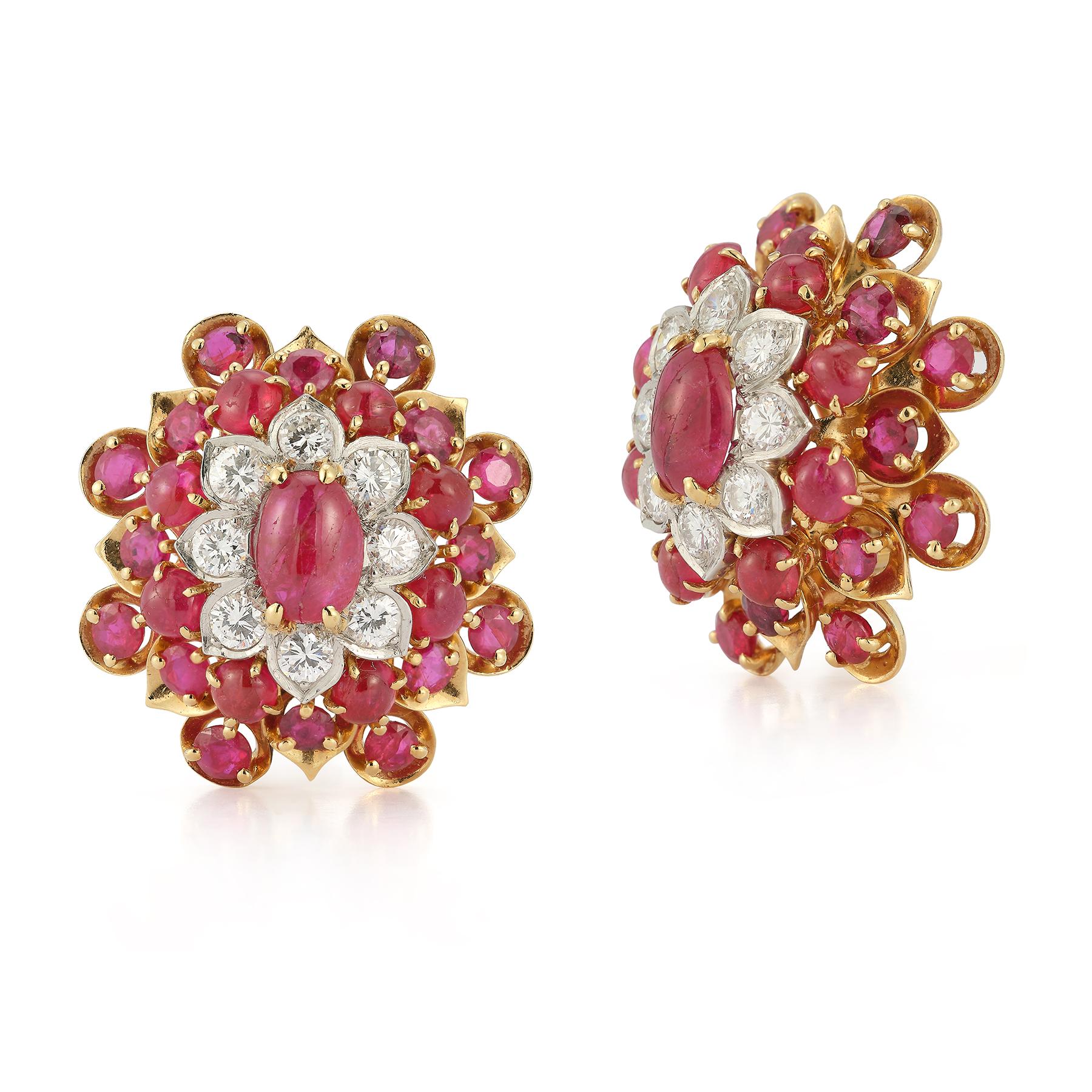 David Webb Ruby Earrings

Cabochon  center ruby surrounded by round cut diamonds & cabochon rubies forming a flower motif set in 18k yellow gold & platinum.

Measurements: 1