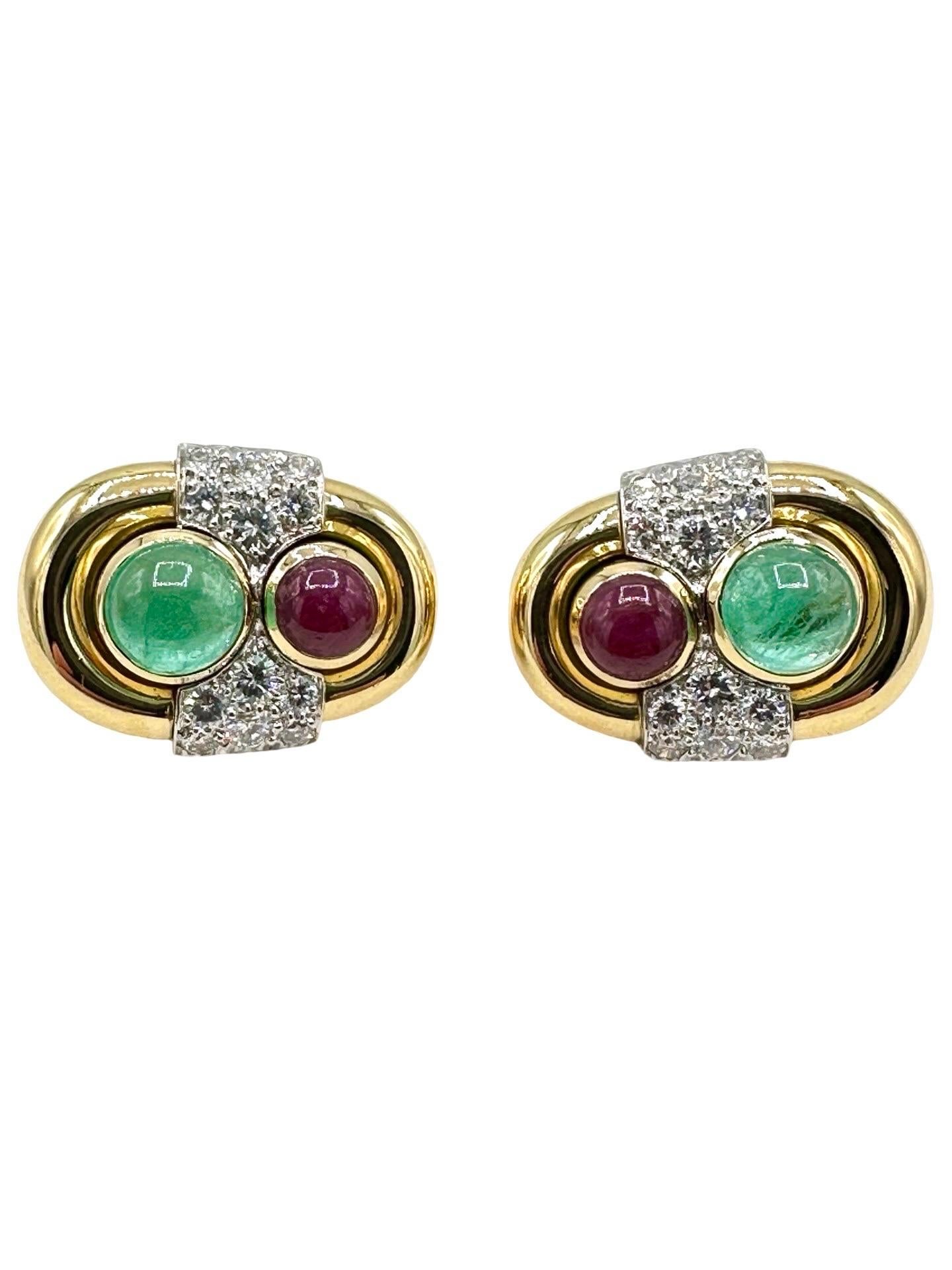 A gorgeous pair of David Webb clip on earrings!  These earrings are made with a bezel set cabochon Ruby on top, a bezel set cabochon Emerald on the bottom, and round brilliant Diamonds in between the two.  The Ruby and Emerald are set in 18 karat