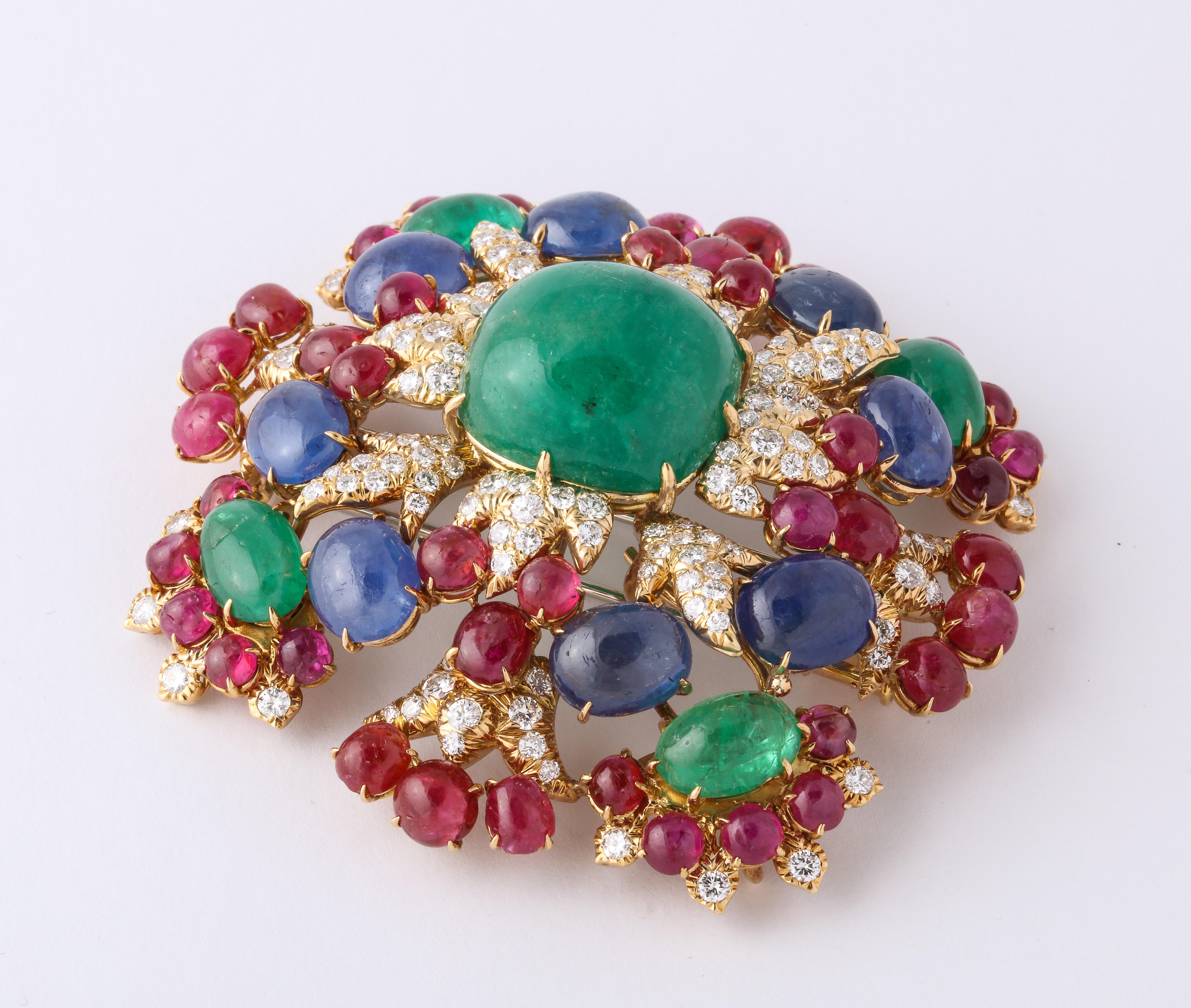 David Webb Brooch  And Pendant in 64 gm of yellow gold, 124 full cut diamonds, 48 natural ruby cabochons,  8 natural sapphire cabochons,  5 natural emerald cabochons. It is marked Webb 18 and can be worn as a pin in a square shape and as a pendant. 