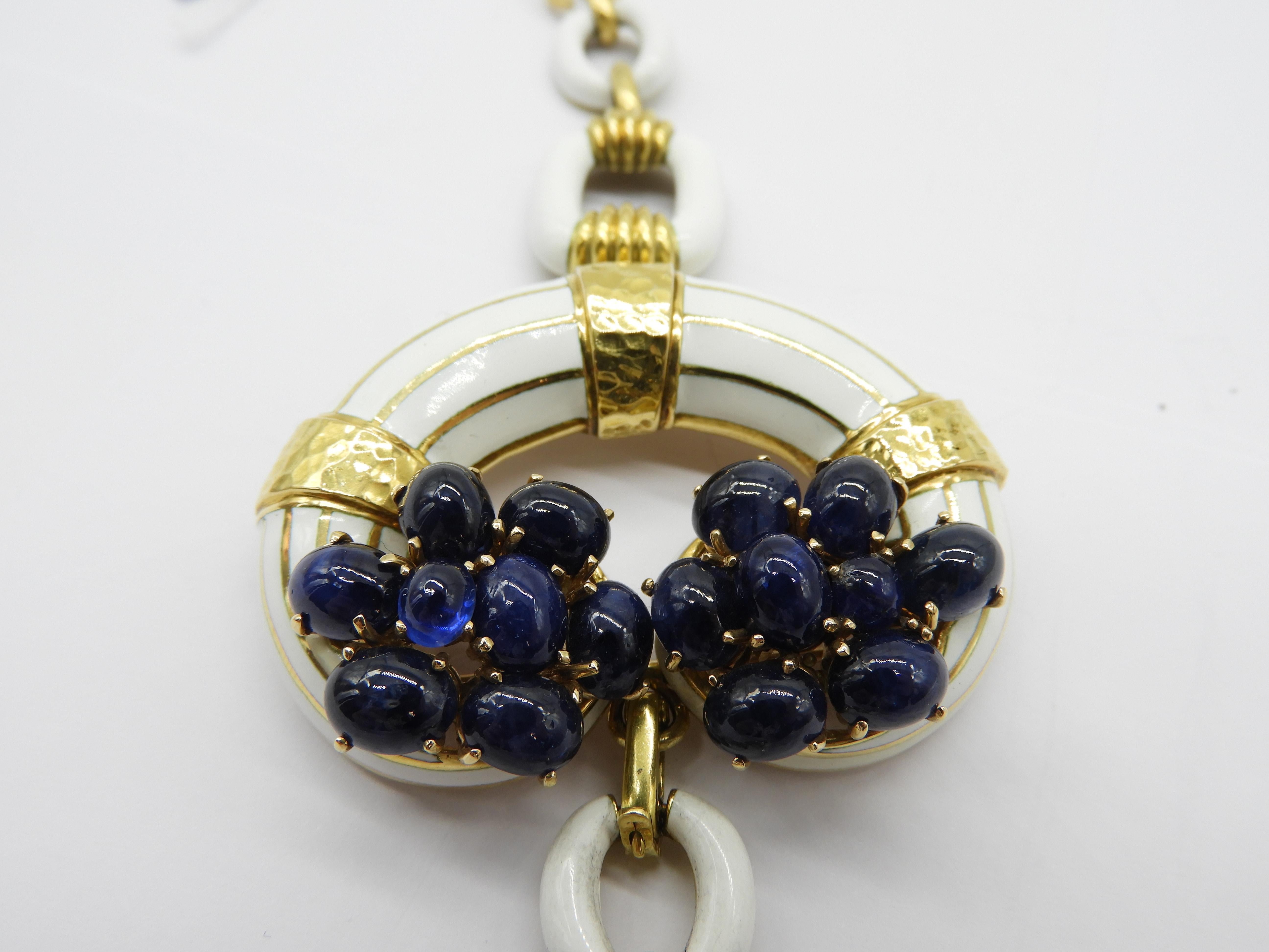 DAVID WEBB
Sapphire Cabochon and enamel link bracelet  with a central C in 18k gold and convertible into brooche. 
DAVID WEBB (USA, 1925–75)
“Women are tired of jewelry-looking jewelry,” celebrated American designer David Webb once noted. In