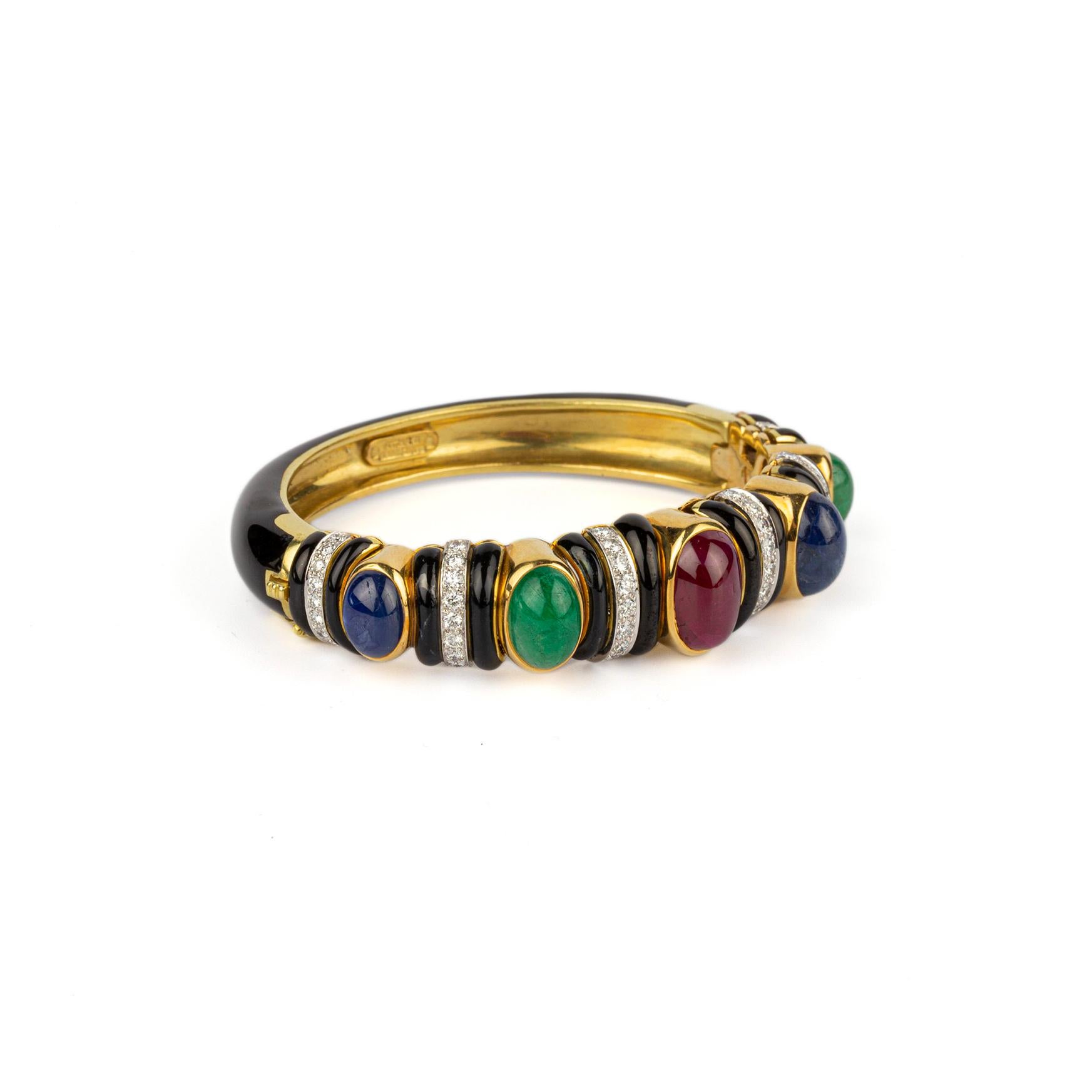 David Webb 18k Yellow Gold Bangle Bracelet, with cabochon Sapphires, Emeralds, and Rubies. Made in the USA, circa 1975.