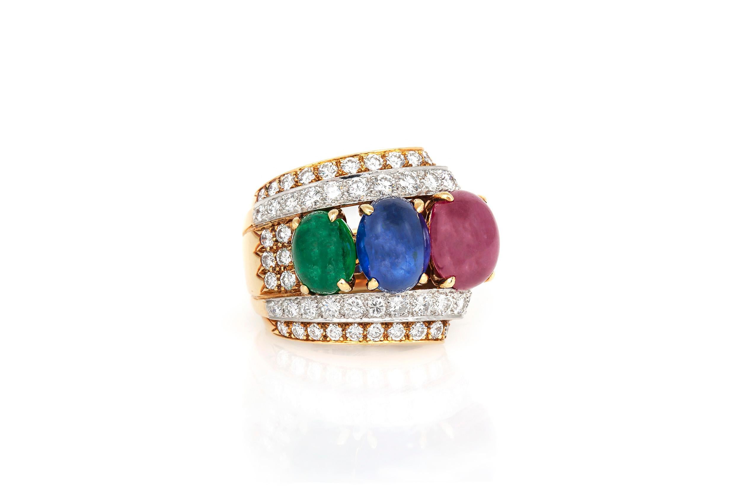 Finely crafted in 18k yellow gold and platinum with a 5.71 carat Cabochon Ruby, a 4.94 carat Cabochon Sapphire, a 2.25 carat Cabochon Emerald, and 2.03 carats of round brilliant cut Diamonds.
Signed by David Webb.
Circa 1970's.
Size 5 1/2