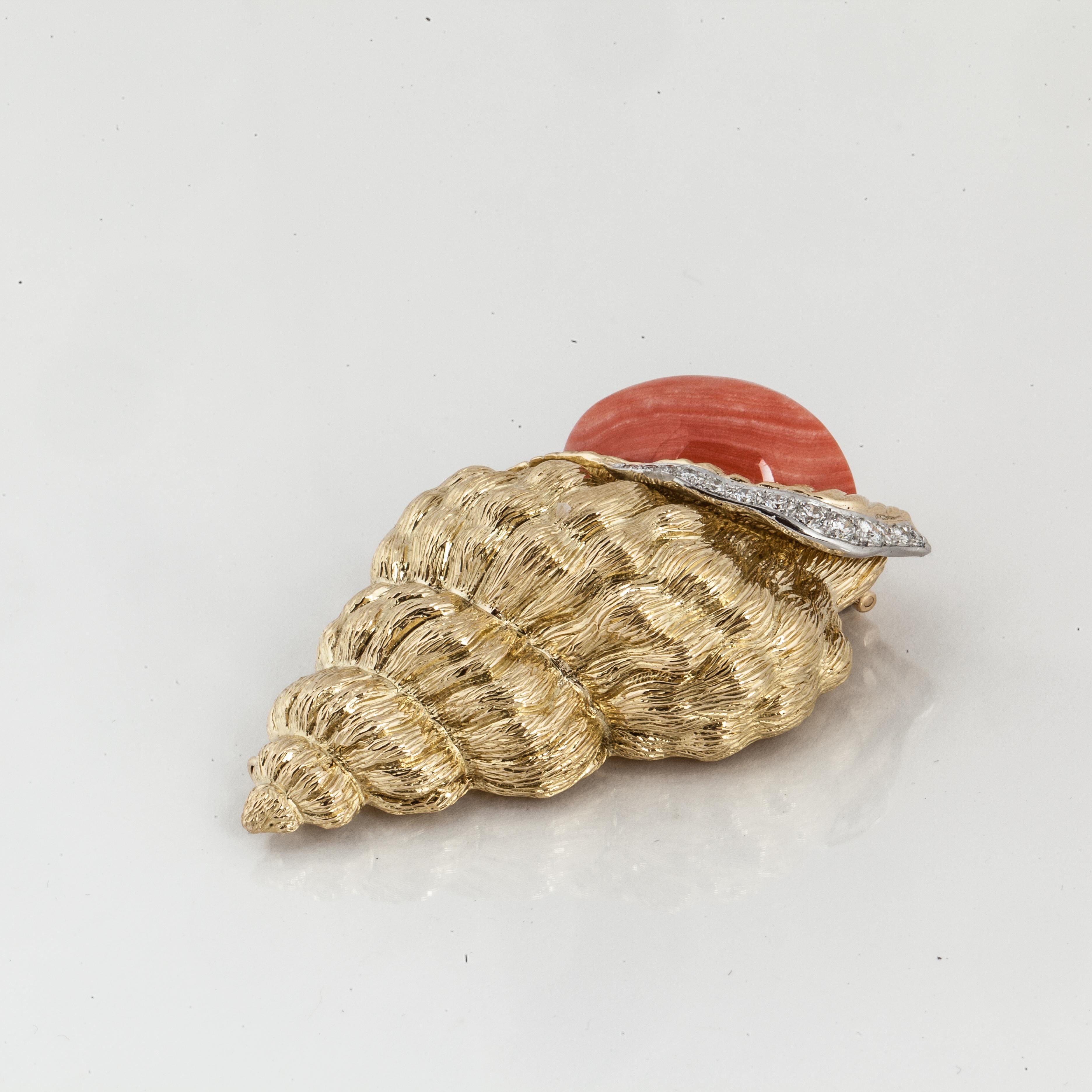 David Webb brooch depicting a shell in 18K yellow gold with coral and diamonds.  It is marked 