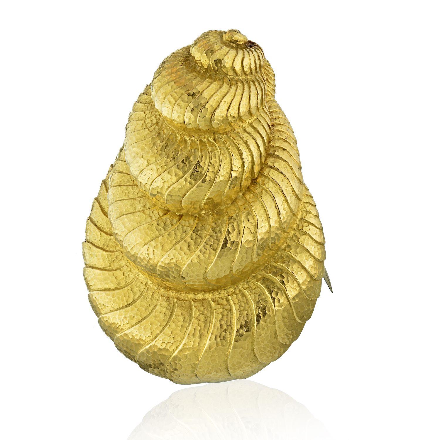Stunning seashell style brooch by David Webb. Perfect for all of you ocean lovers to wear on a summer day clipped onto your favorite blouse, scarf or even a bag. It is of a medium to large size, finished in a traditional Webb hammered-finish. Double