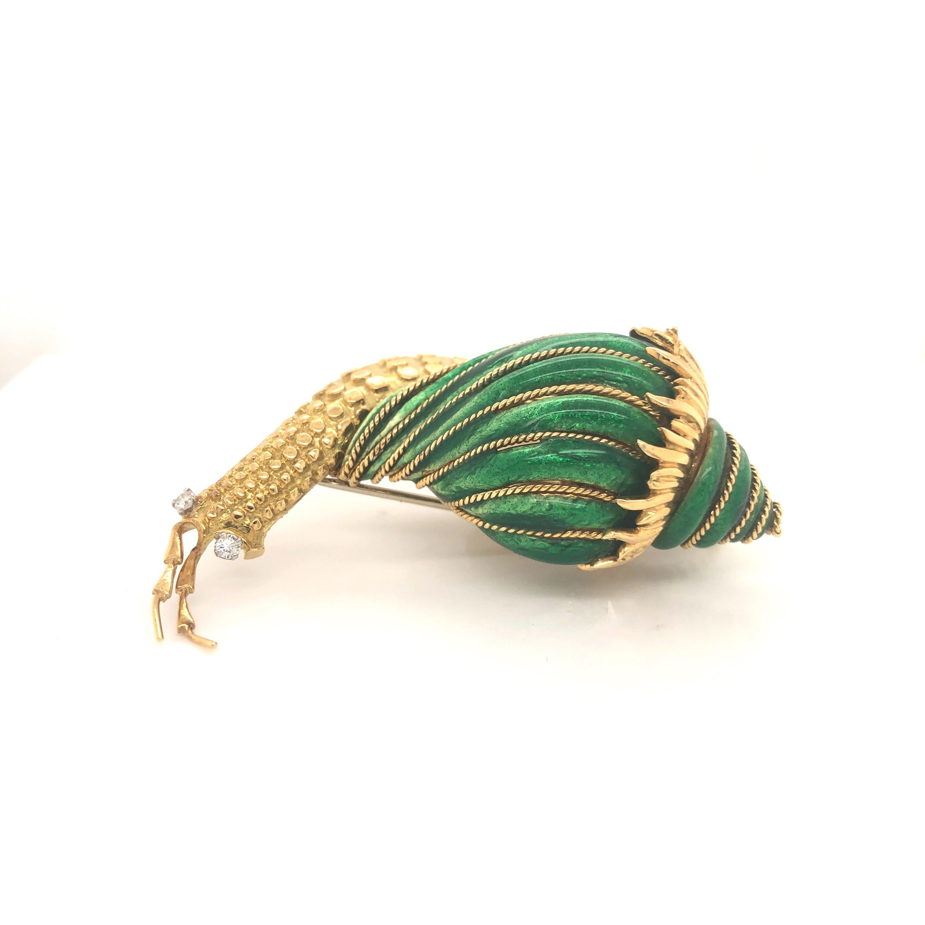 David Webb enamel and diamond 18 karat gold snail clip brooch circa 1980. The design features a representation of a snail in forward march carrying its striped, brilliant green enameled shell embellished with corded gold. The diamond-set eyes