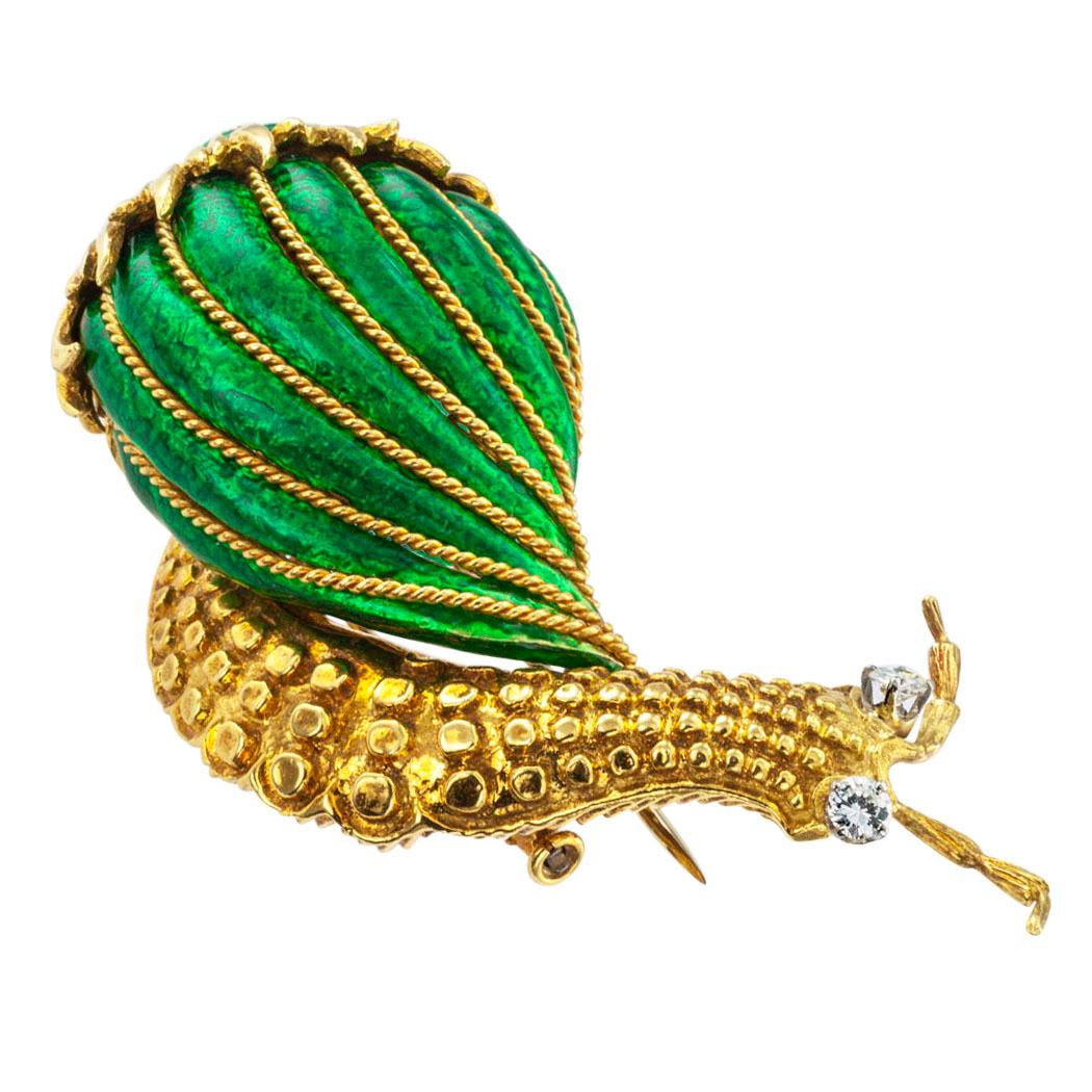 David Webb diamond and enamel 18 karat gold snail clip brooch circa 1980.  The figural design features a representation of a snail in forward march carrying its striped, brilliant green enameled shell embellished with corded gold, the diamond-set