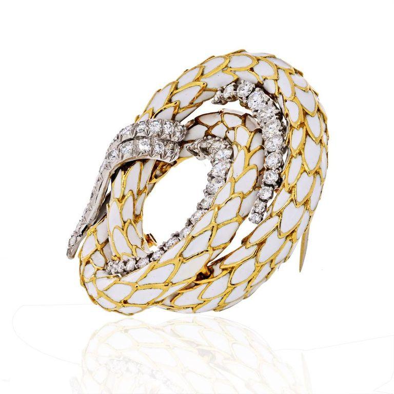 Crafted out of 18K gold and platinum, with a coil design, featuring white enamel scales, enhanced by 50 round-cut diamonds, weighing a total of approximately 3.50 carats, with G-H color and VS clarity; completed with a double pin stem with a
