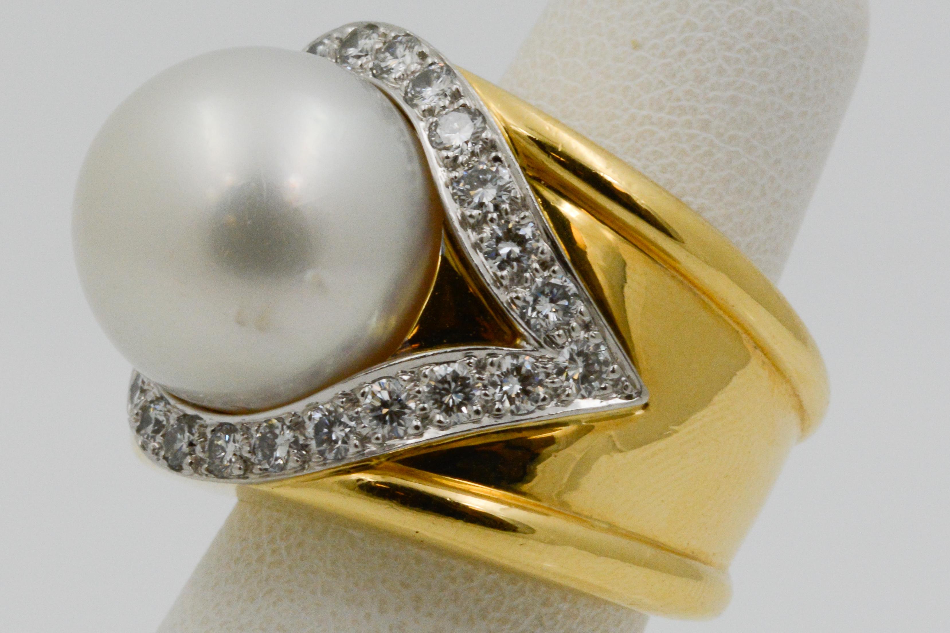 This David Webb ring is 18K yellow gold and platinum with a geometric design; set 14.85mm South Sea pearl and 1.00ctw round brilliant 24 diamonds (G color and VS clarity). Expertly set in a teardrop halo surrounding the pearl. Ring comes in size 4.5