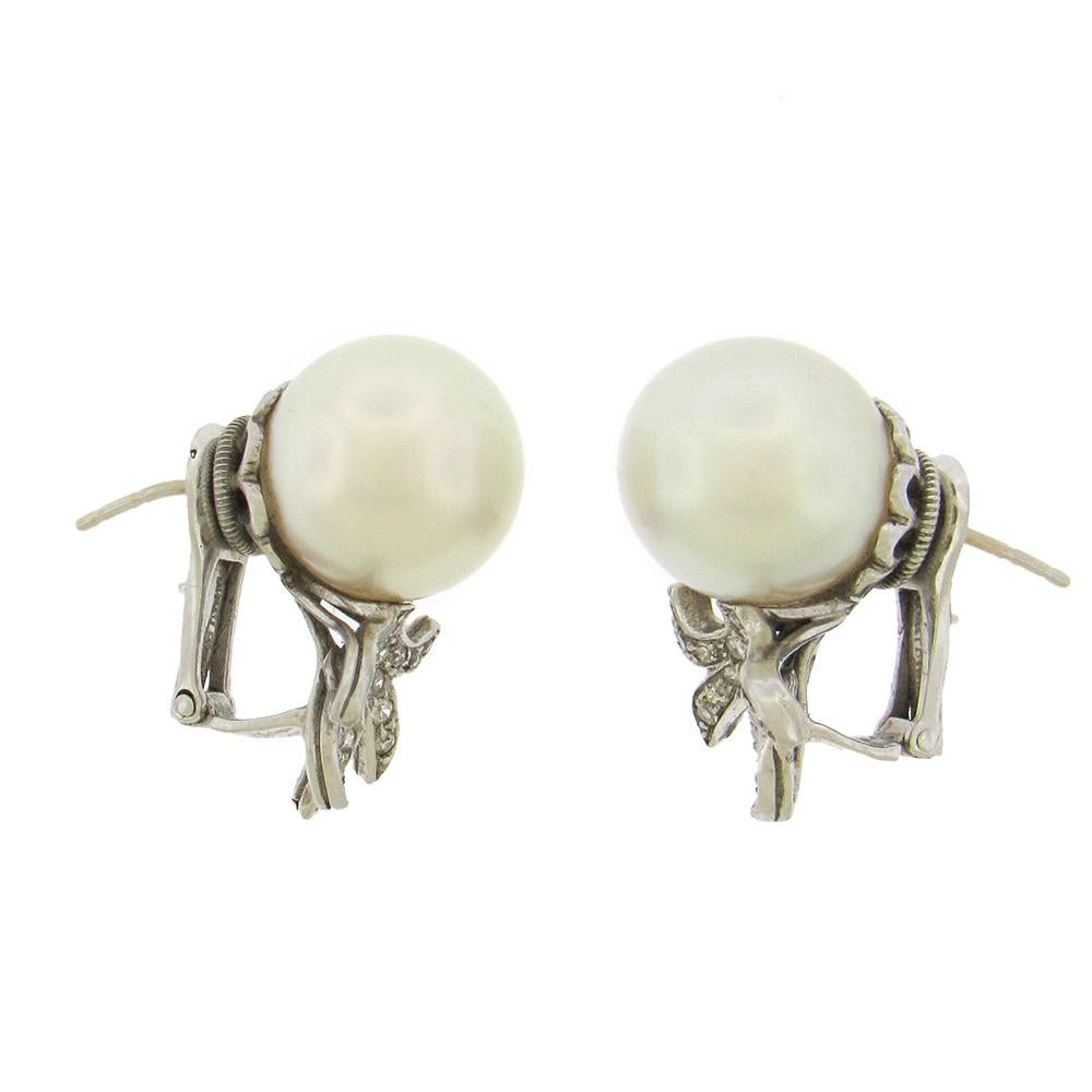 Large lustrous platinum-white 12.5mm South Sea pearls are the focal point of David Webb's charming earring, set in platinum with a diamond spray design. 1