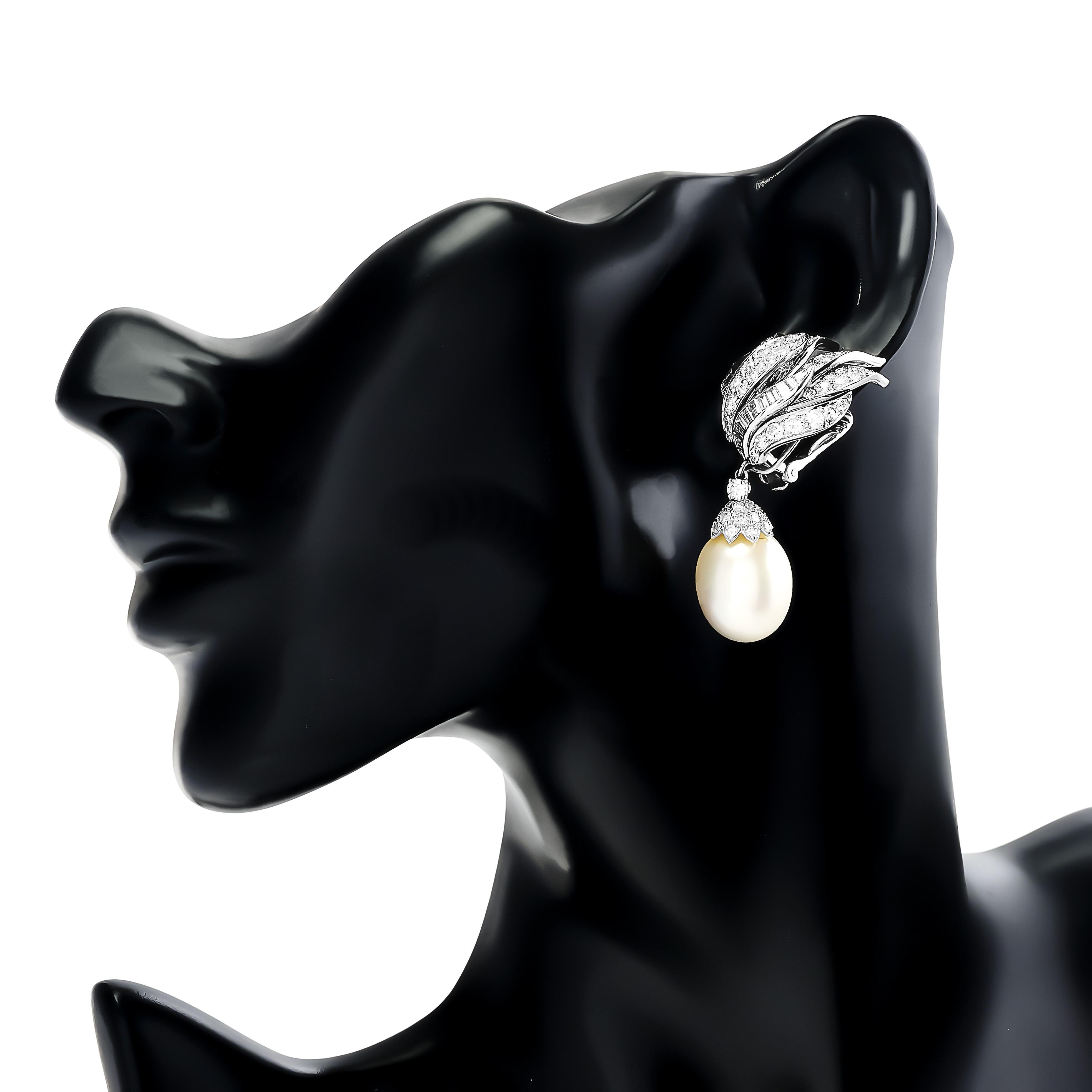 The pair of David Webb diamond flame earrings captivate with their fiery design, accented by detachable pearls that add a touch of elegance and versatility to the stunning ensemble.

The mix of round and baguette diamonds are approximately 6.00