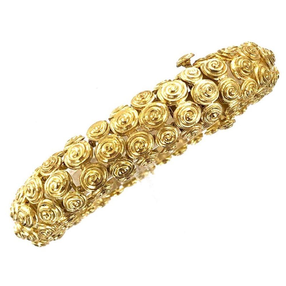 David Webb Webb Swirl 18 Karat Yellow Gold Textured Bracelet David Webb swirl bracelet fashioned in 18 karat yellow gold. The textured bracelet measures 7.75 inches in length and .60 inches in width. Signed Webb 18K. 