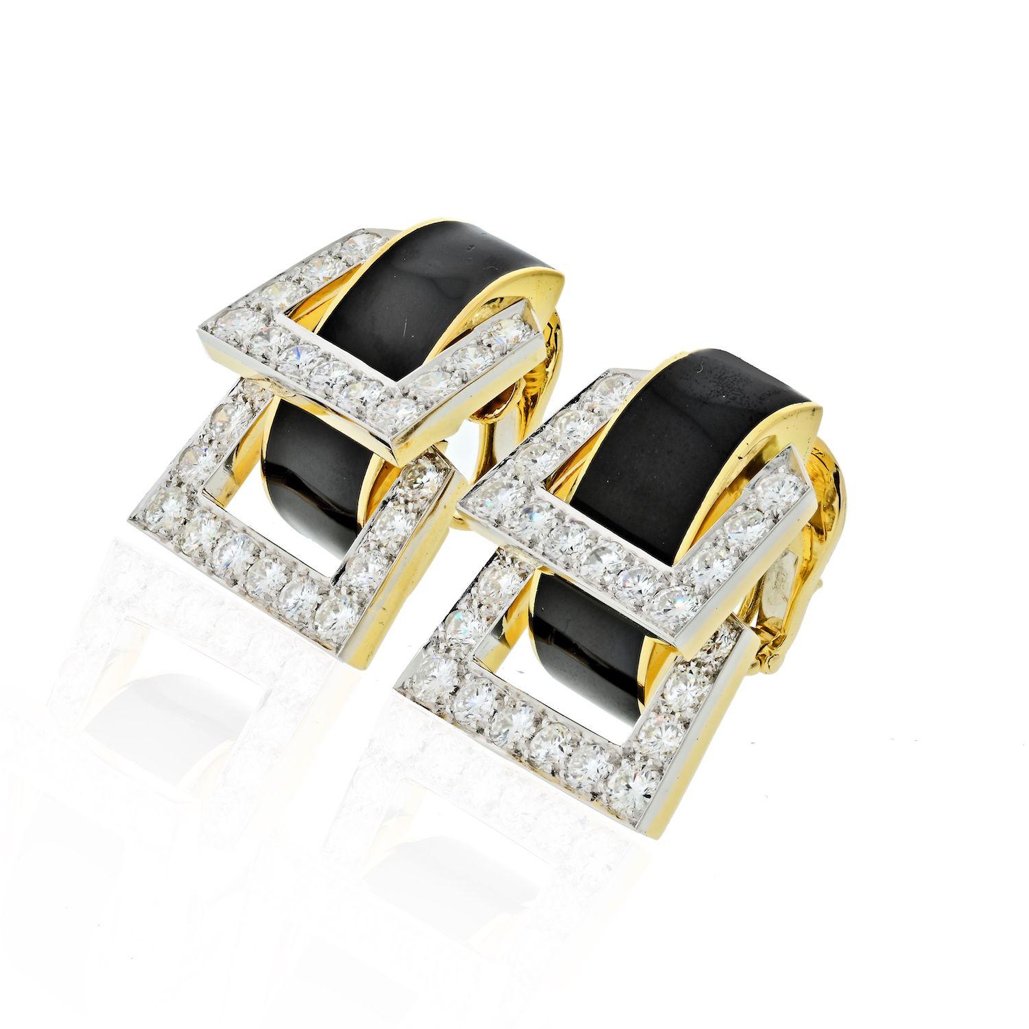 An iconic pair of black enamel coated 18 karat yellow gold and platinum strap design earrings with diamond encrusted edges.
Diamonds: 48 Round Brilliant Cuts.
Quality: 4.55 total carat weight, F-G color, VS1-VS2 clarity. Earring length 30mm.
Style: