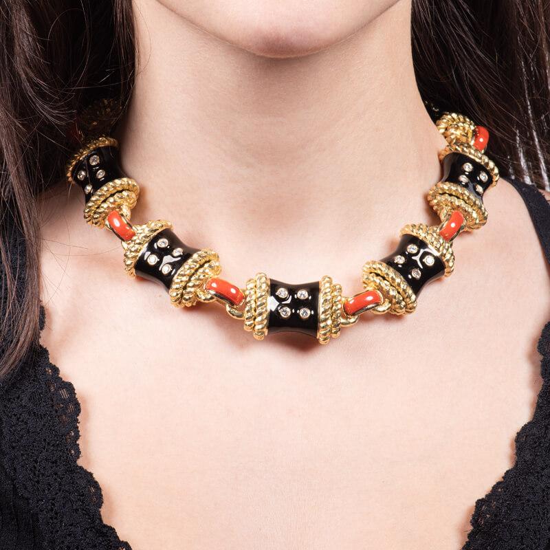 This extravagant David Webb design is the Stud Necklace from the Manhattan Minimalism collection. This link necklace is made of carved coral, 2.41ct total weight in collet-set round brilliant cut diamonds, black enamel, 18kt gold, and platinum. This
