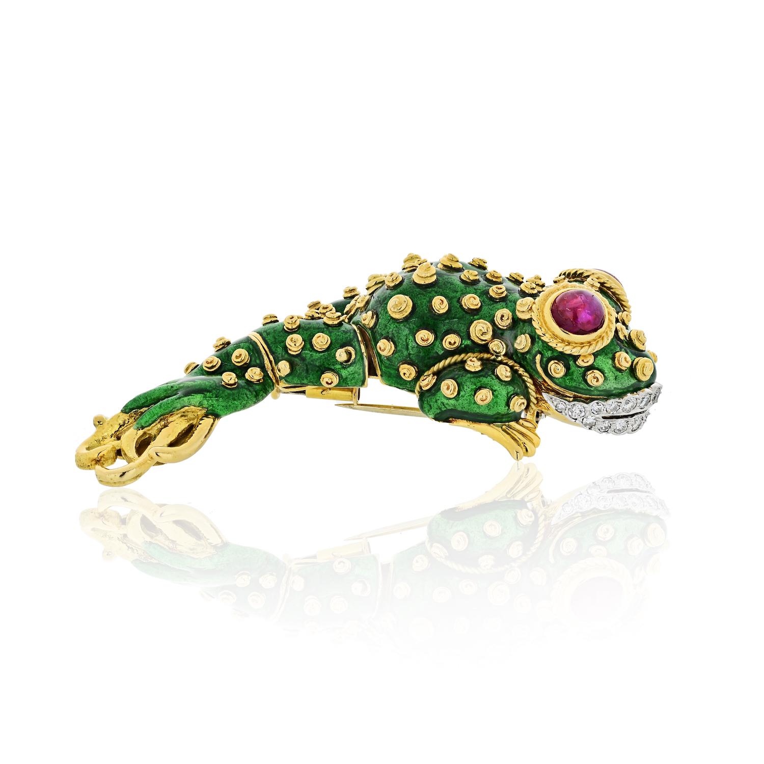 Questions? Call us anytime!
The Back Vault NYC.
833,998,2858

18 kt., the stylized tadpole applied with green enamel and applied gold spiral spots, with two collet-set oval cabochon ruby eyes further edged by twisted gold, its platinum lips set with