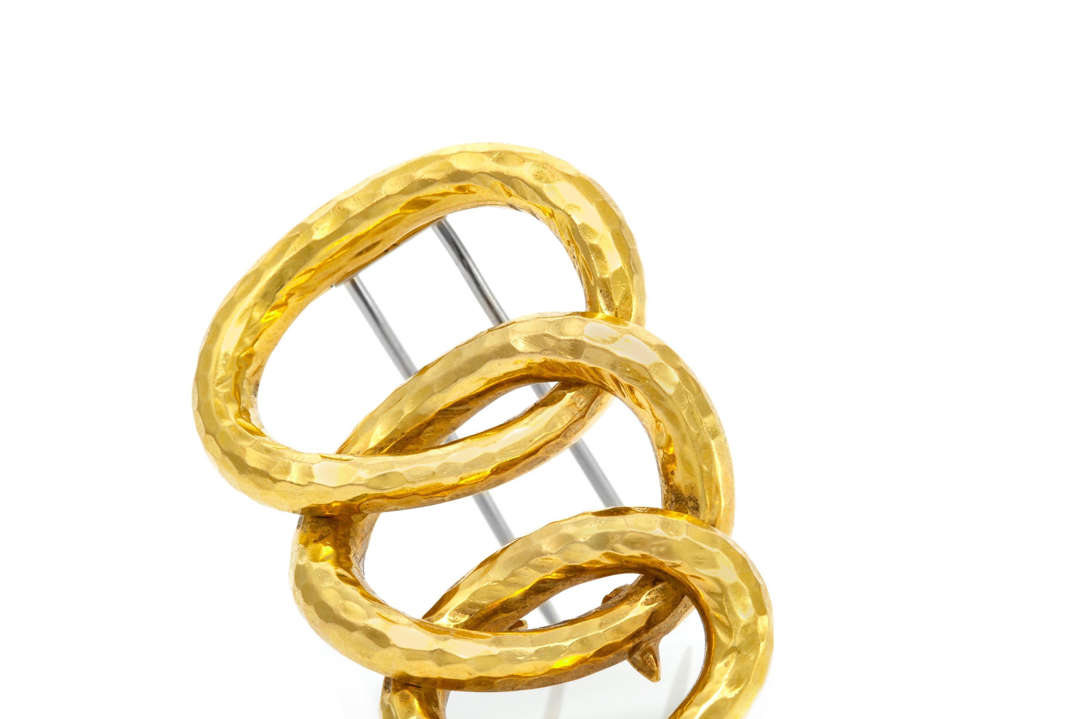 David Webb broch is finely crafted in 18k yellow gold and weighing approximately a total of 14 DWT.

sign David Webb.