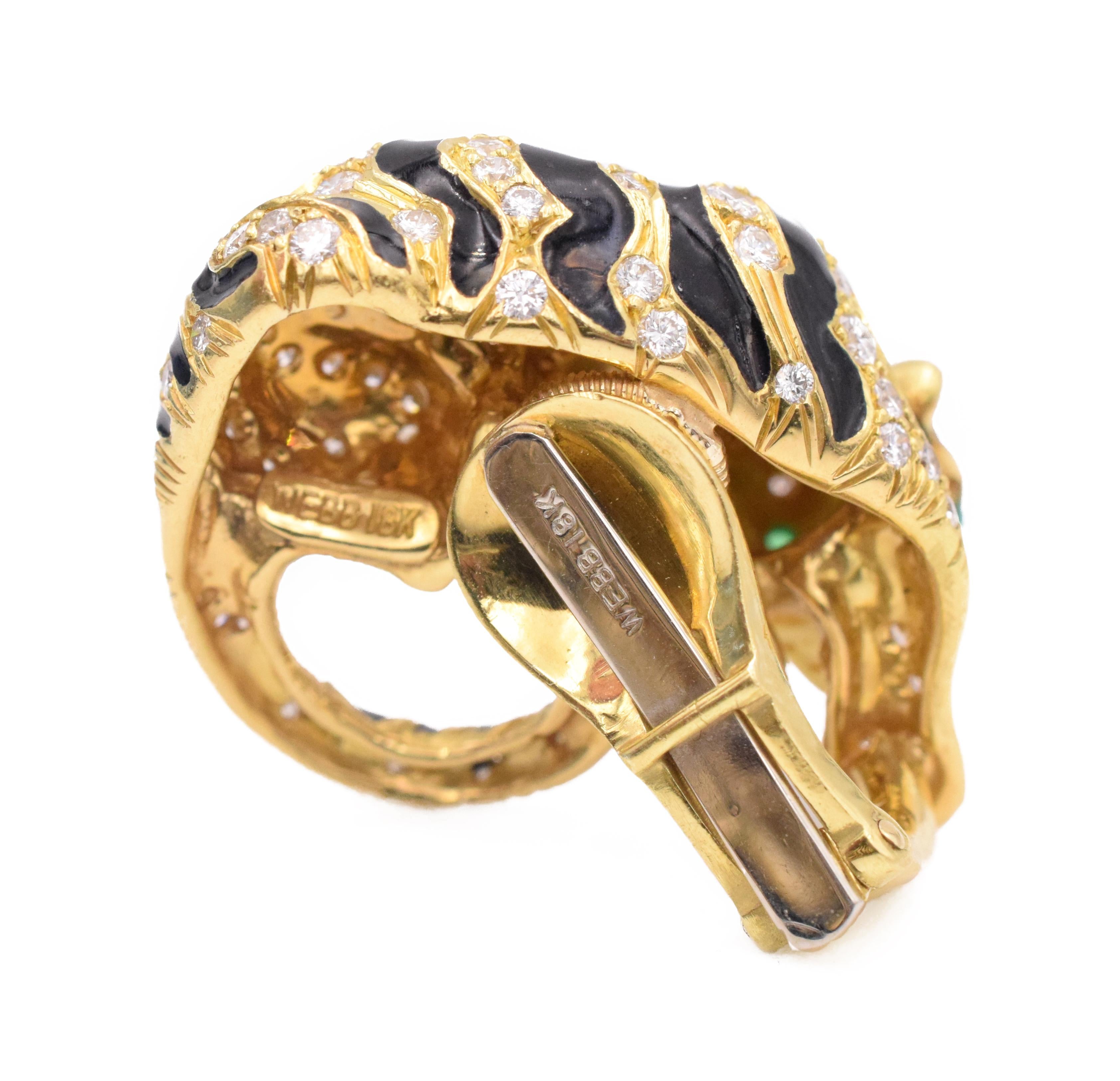 David Webb tiger ear clips with bands of black enamel and round diamonds forming the stripes, the eyes set with cabochon emeralds, The diamonds,  weigh approximately 3.30 carats,  
 Length approximately 1.00 inch each.
Signed David Webb