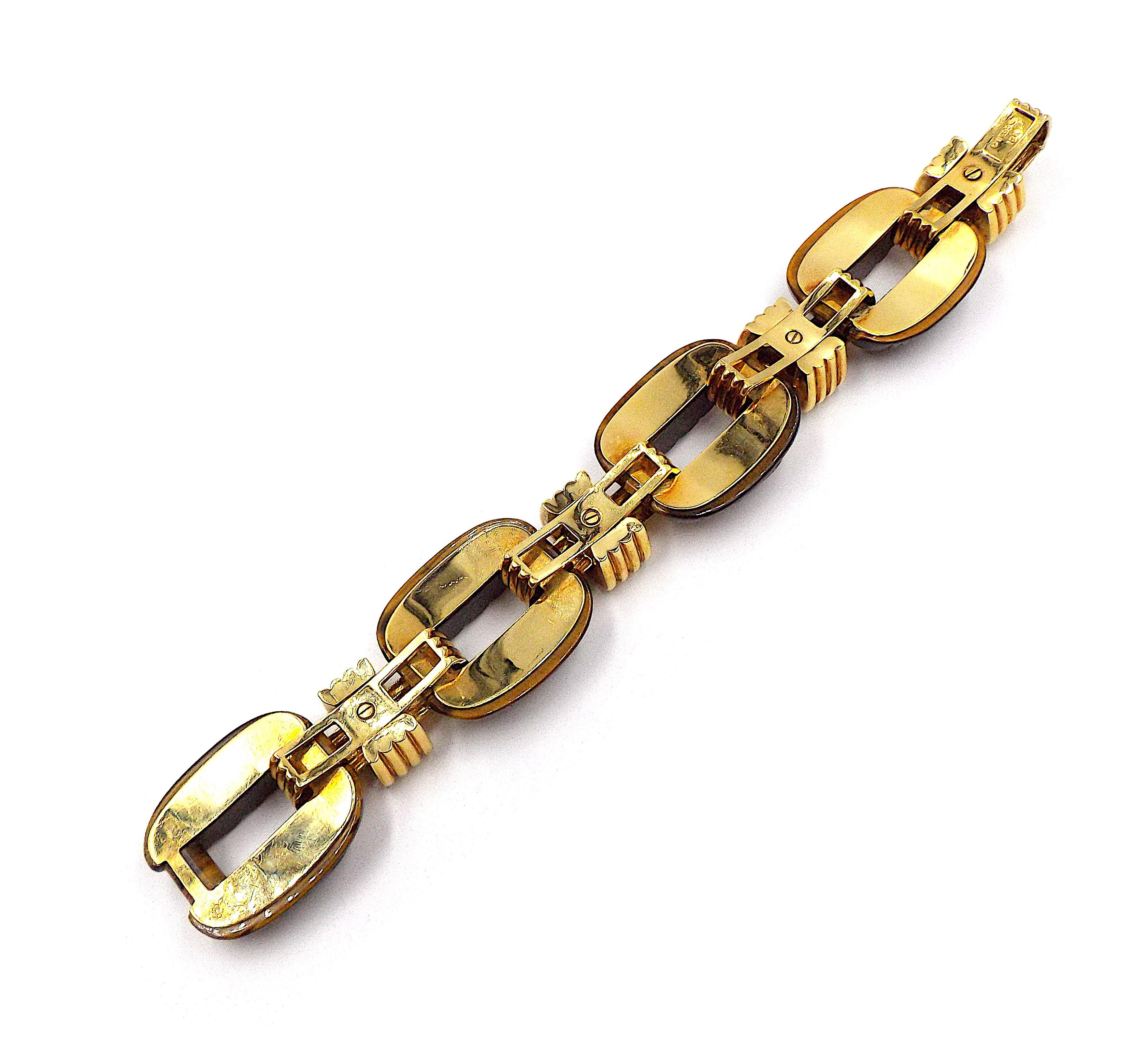 A classic link bracelet by David Webb. 18K yellow gold featuring large carved tiger eye links. Signed Webb, marked 18K. Length is approximately 6.75 inches.