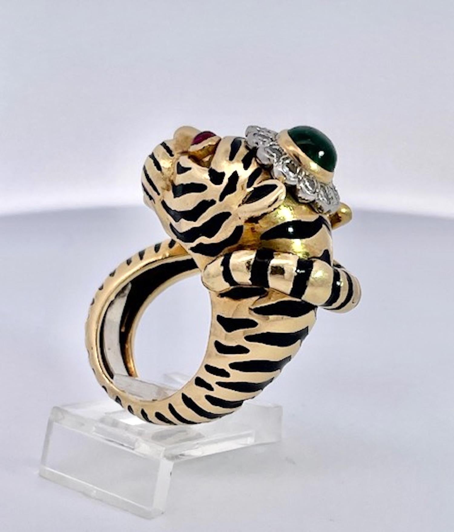 This amazing David Webb Tiger ring has all the bells and whistles.  It is gently used and in great shape.  This ring boosts Ruby eyes and an Emerald Crown on his head.  The Rubies and Emerald are Cabochon cut and the stripes are in really good