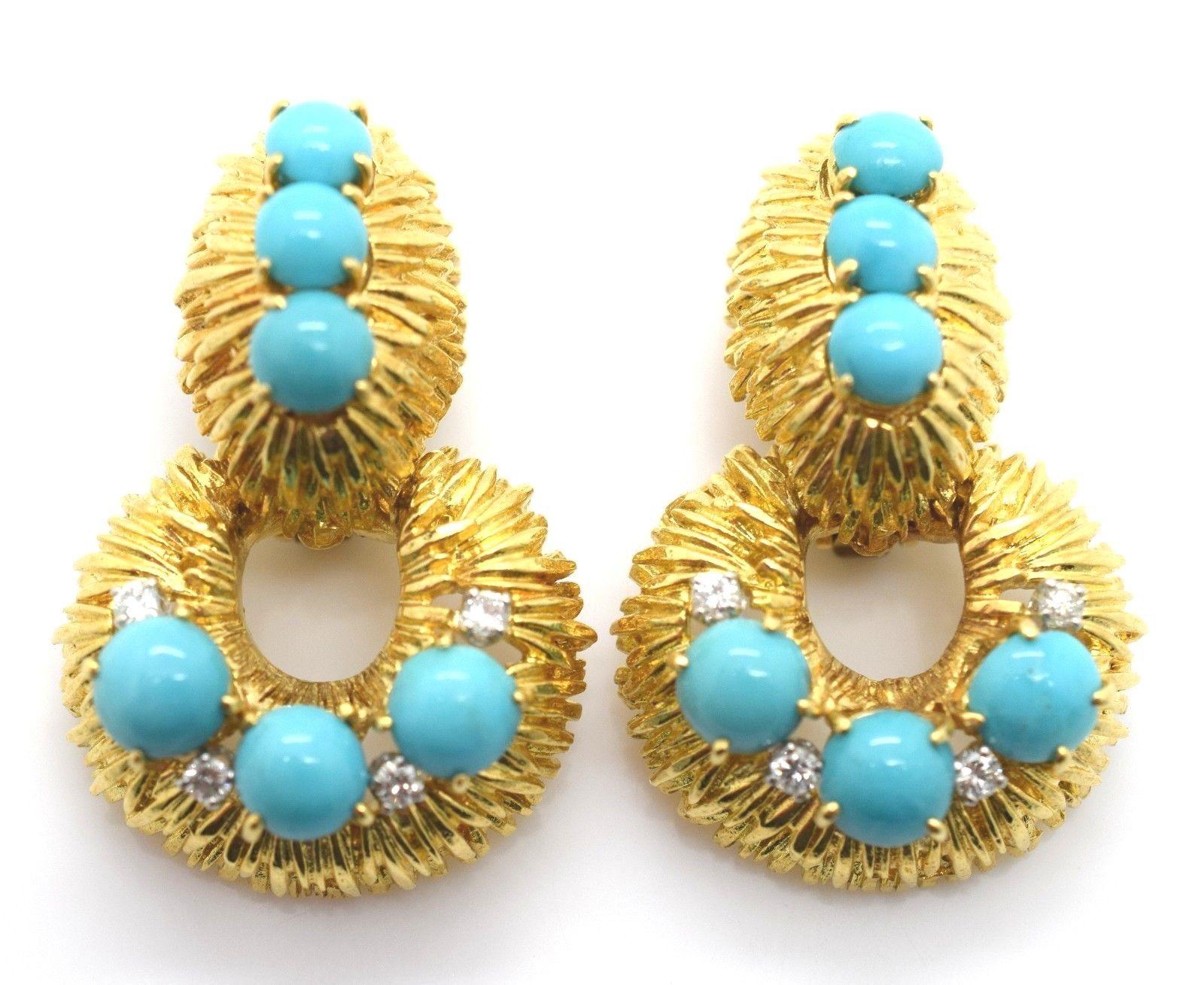 A beautiful pair of famed designer David Webb Door Knocker Earrings. The earrings are set with amazing natural Turquoise cabochons 12 stones in total on the pair. Four Diamonds on each earring. The textured design of the gold is a one of a kind