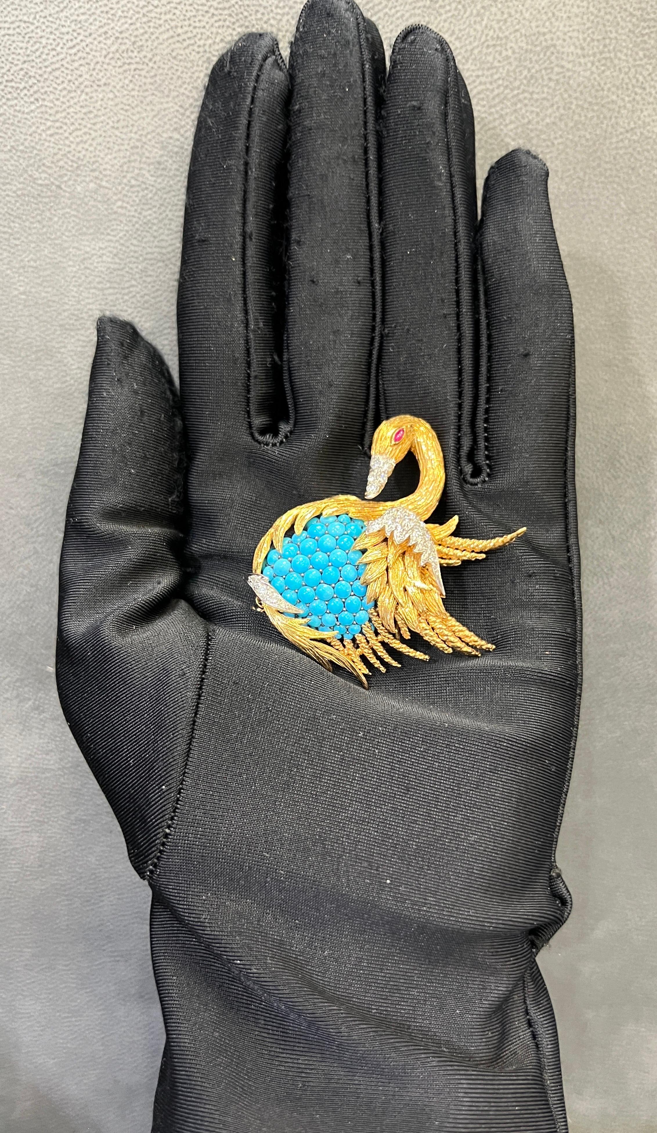 David Webb Turquoise & Diamond Swan Brooch

A Brooch featuring cabochon turquoise clustered together with round cut diamonds & one marquise cut ruby. 

Measurements: 1.5