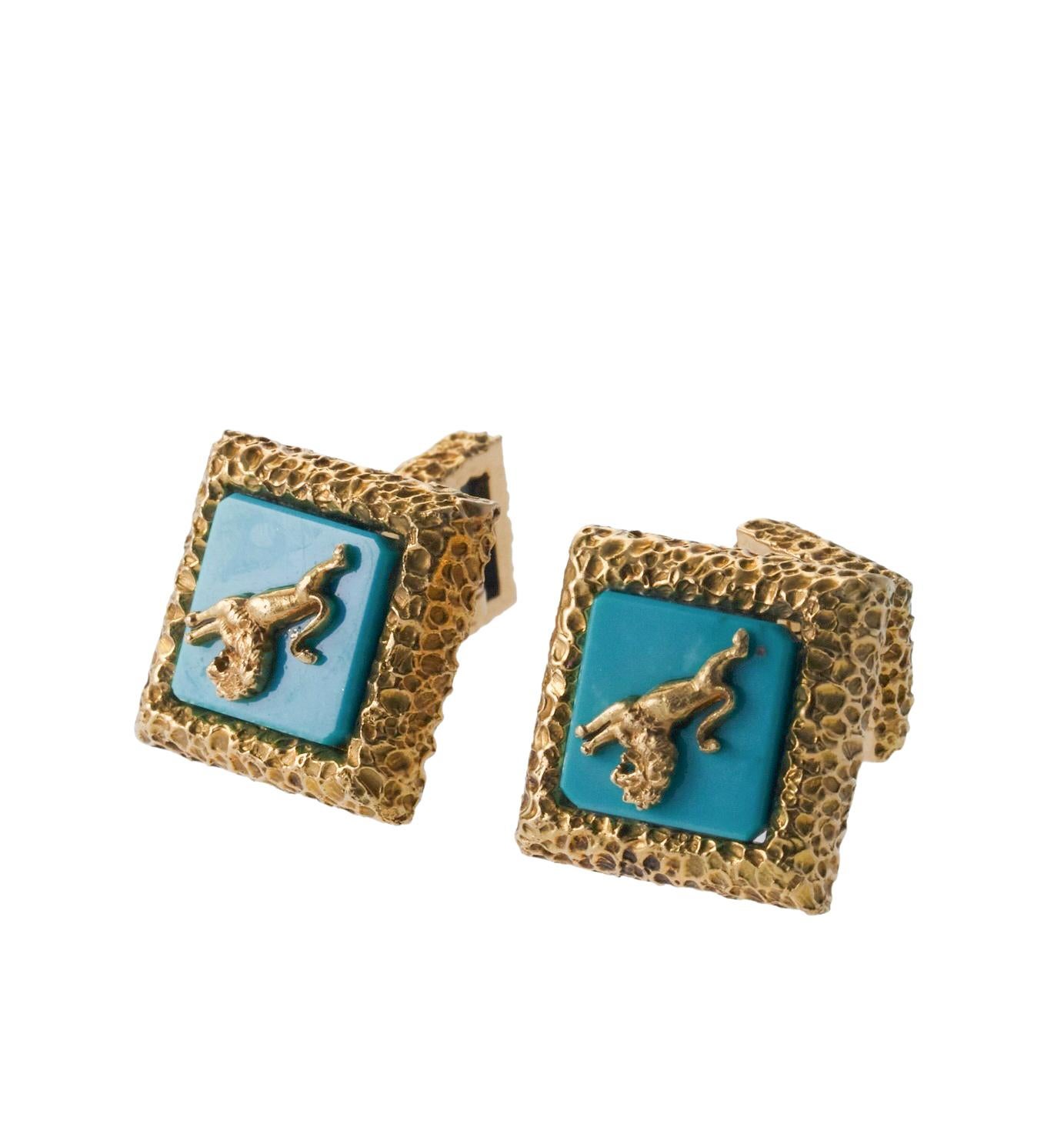 Pair of 18k gold lion cufflinks by David Webb, set with turquoise. Cufflinks top measure 18mm x 18mm, back is 11mm x 11mm. Marked: Webb, 18k. Weight is 30.8 grams.