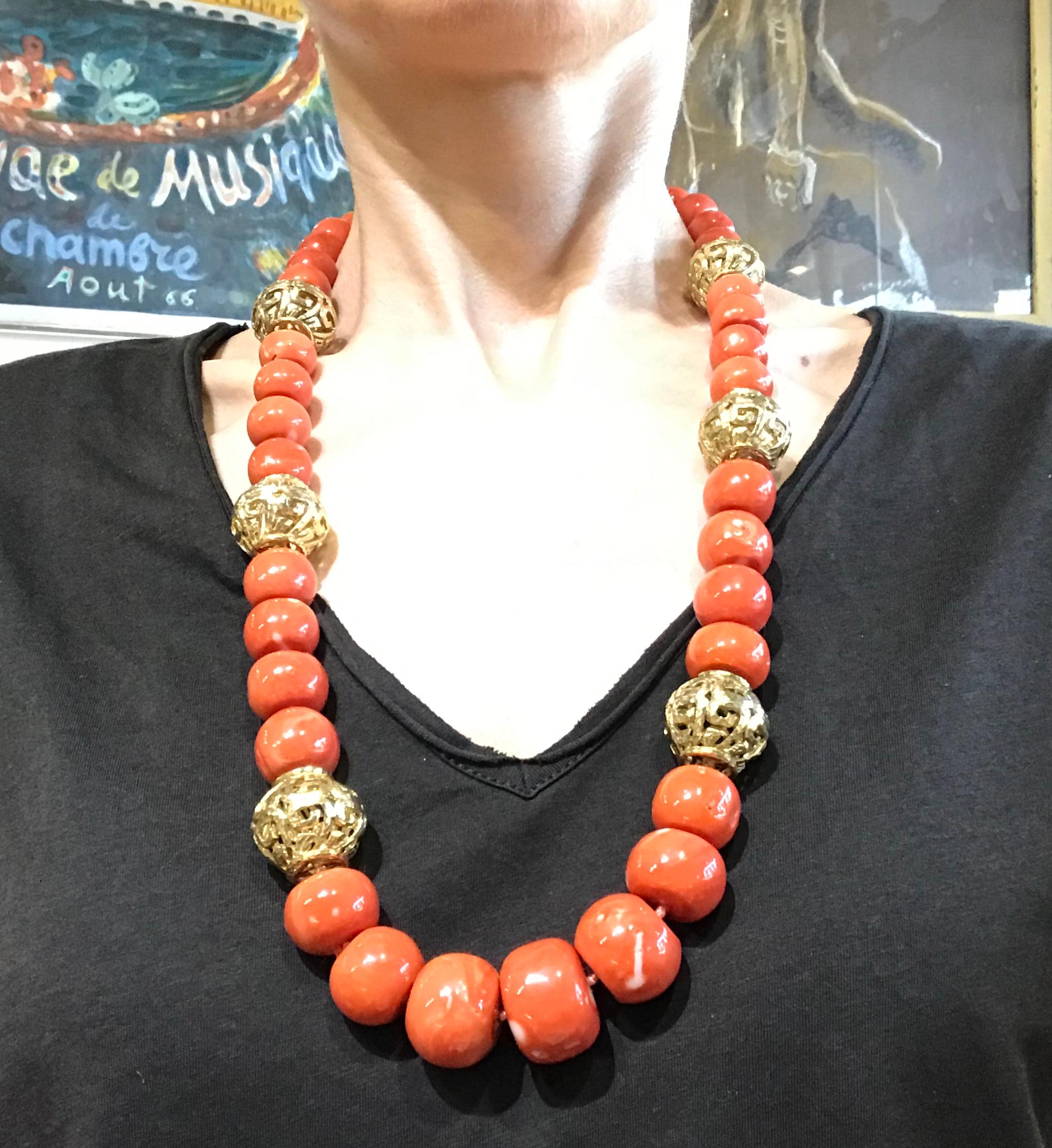 Long voluminous necklace by David Webb made of coral beads and hammered 18k yellow gold. An impressive piece from 1980s. Coral beads size gradually changes from the top to the bottom.
Stamped with the David Webb maker's mark and a hallmark for 18k