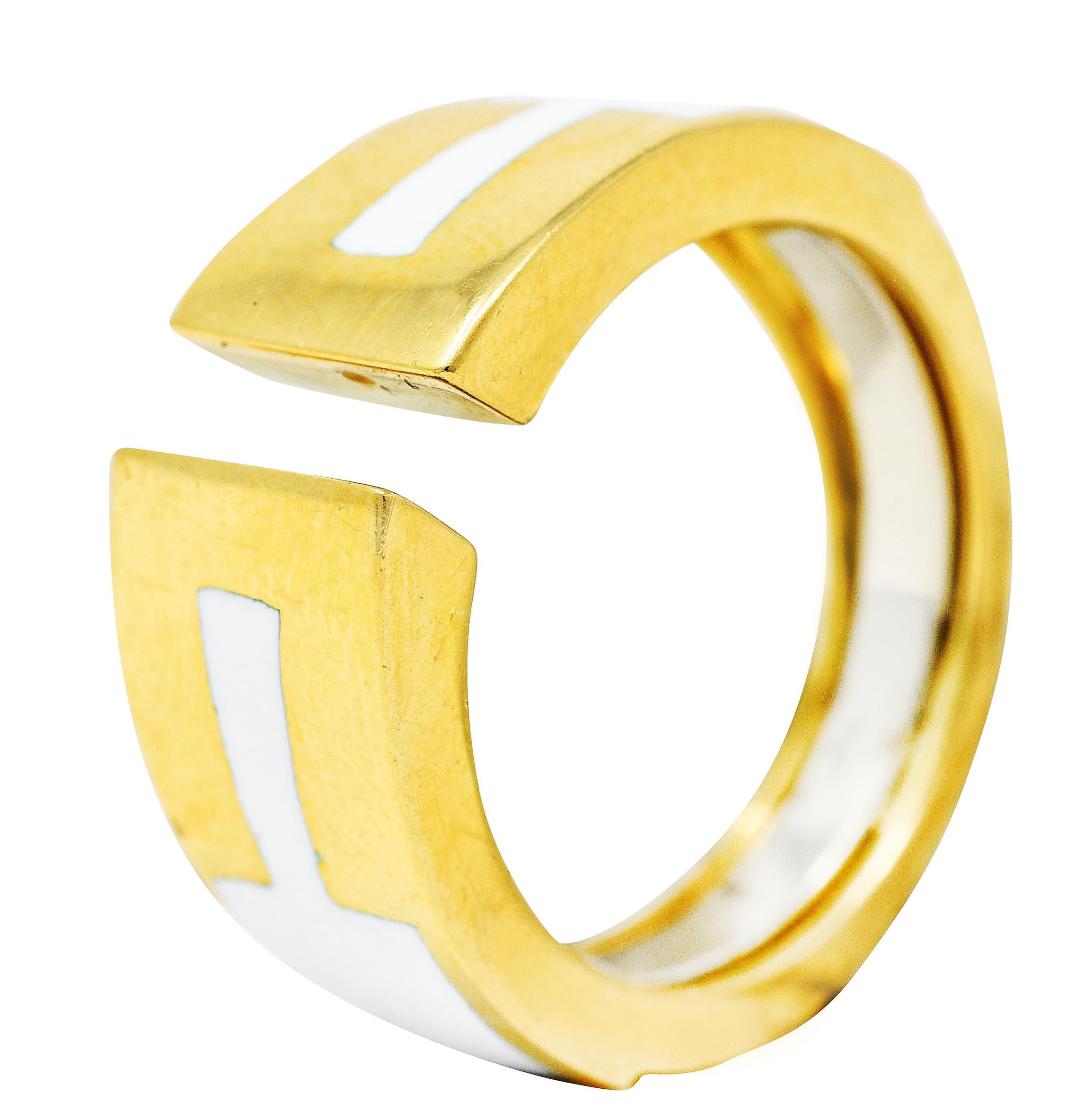 Band ring designed as highly polished gold centering a gap

Shoulders feature geometric panels of enamel

Intact high gloss and opaque white enamel

Stamped 18k for 18 karat gold

Signed Webb for David Webb

From the early Motif collection

Ring