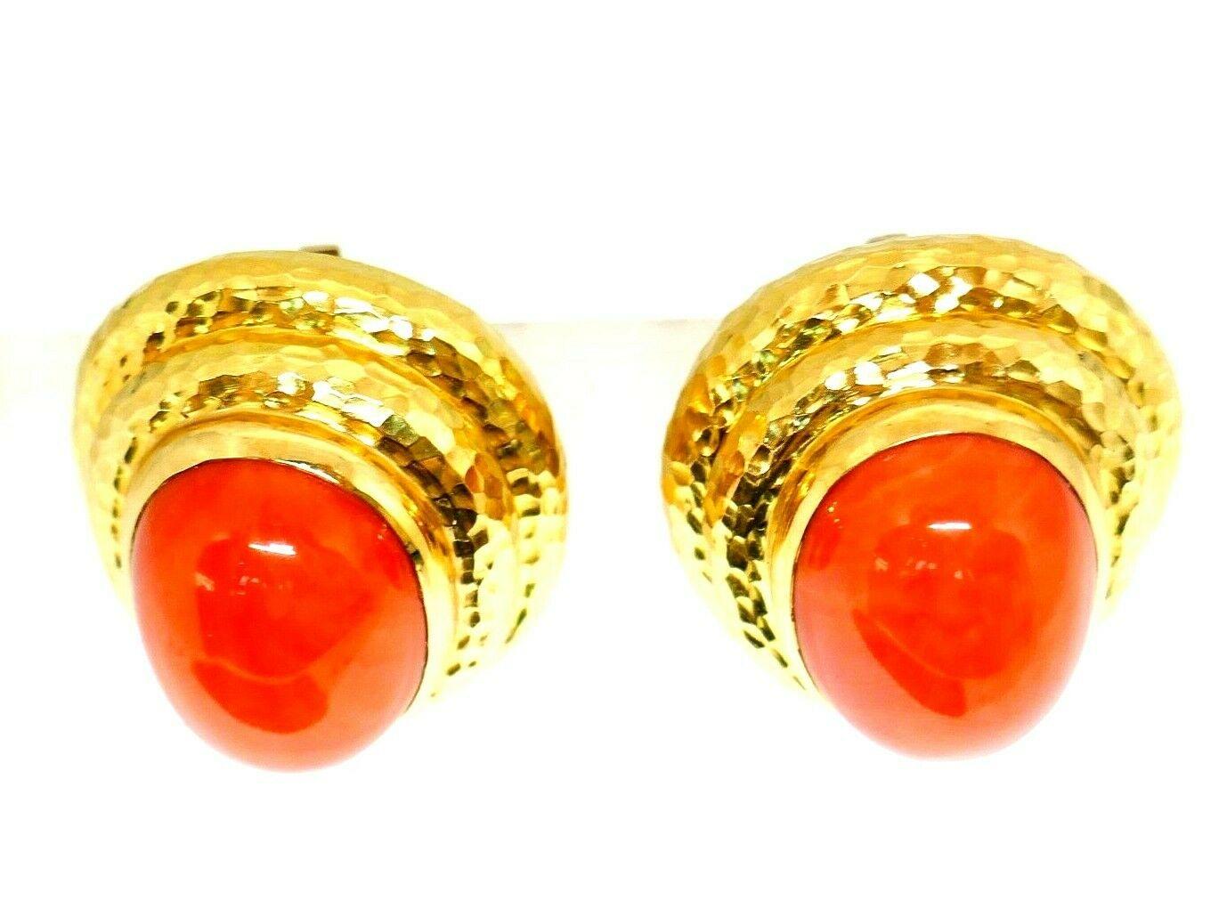 Gorgeous statement earrings by David Webb. Beautiful polished coral framed in shiny hammered 18k yellow gold. Circa 1970s. 
Stamped with the David Webb maker's mark and a hallmark for 18k gold.
Measurements: 1 3/8