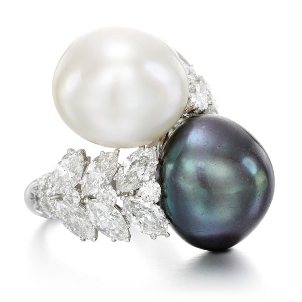 David Webb White and Black Pearl You & Me Ring

One grey (16.2 x 17.0mm) & one white (16.1 x 16.3mm mm) pearl set with marquise & round cut diamonds approximately 4.91 cts set in platinum

