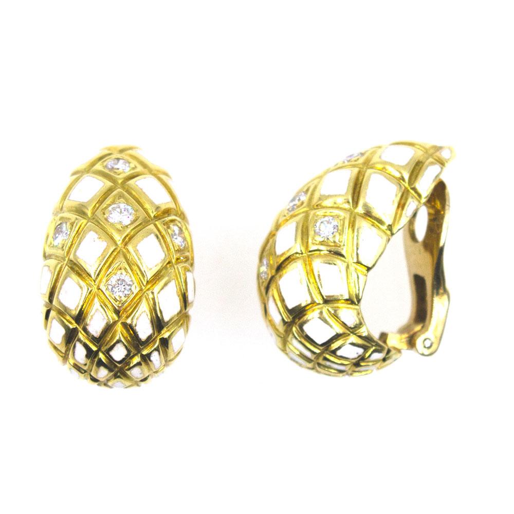 Fabulous David Webb earrings from the Mid-20th Century. These clip on earrings are fashioned in 18 karat yellow gold. The earrings feature white enamel and .50 carat total weight of diamonds. The earrings measure 1.0 inch in length and .50 inches in